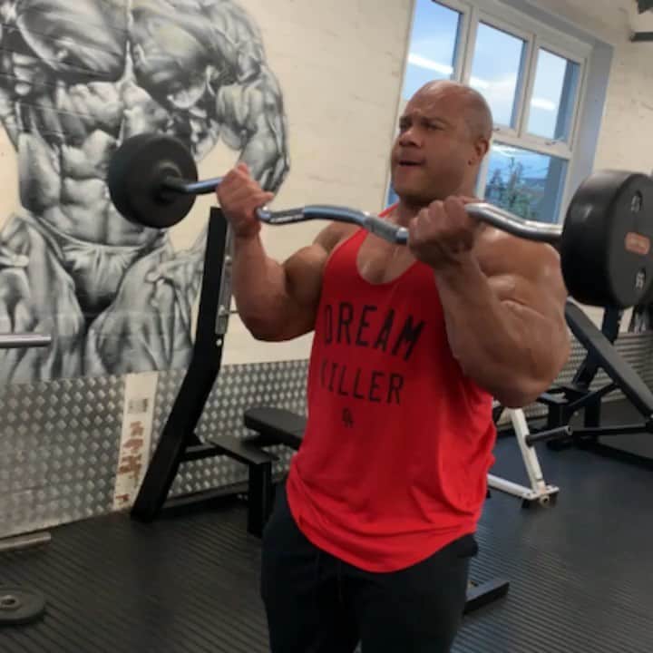 Phil Heathのインスタグラム：「Was training arms and my friends at @emporiumgym captured some good negatives with me using the EZ AF curl bar lol. Gotta love it when your training arms while wearing a @gifted_athletics Dream Killer Stringer and your arms are on Swole!!!!! I told y’all I ain’t playa around this year. #PhilHeath #7xMrOlympia #Retribution #giftedathletics #DreamKiller」