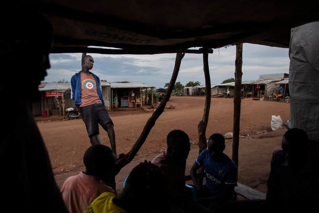 ナショナルジオグラフィックさんのインスタグラム写真 - (ナショナルジオグラフィックInstagram)「Photo by Nora Lorek @noralorek | Three years ago the area in northwestern Uganda containing the Bidibidi settlement was a forest. Now it’s a makeshift home for a quarter million refugees from South Sudan. Peter Wani, 17, built his own small store with money he made doing construction work. He sells items like sugar, snacks, soda, and beer. A group of his friends can often be found sitting outside his shop playing a game called Ludo. The civil war in South Sudan has displaced two million people. Today Bidibidi, the second largest refugee camp in the world, is slowly but surely transforming into a permanent city.」5月12日 15時34分 - natgeo