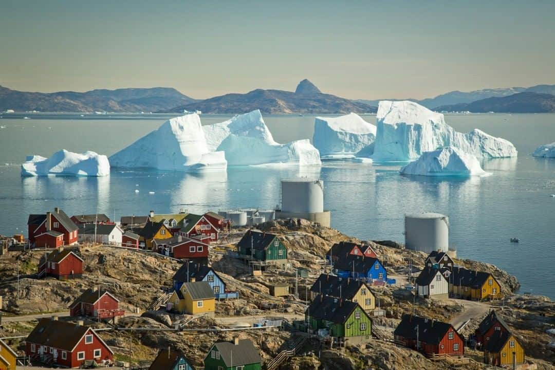 National Geographic Travelさんのインスタグラム写真 - (National Geographic TravelInstagram)「Photo by @acacia.johnson | Massive glacial icebergs loom off the coast of Uummannaq, West Greenland. Fishermen and hunters must remain on high alert while the icebergs are outside the harbor, as a large glacial calving could cause a tidal wave at any time. However, for the people of Uummannaq, ice - and it's constantly changing forms - is a fact of life. Follow me at @acacia.johnson for more stories from the Arctic and beyond. #greenland #uummannaq」5月12日 16時12分 - natgeotravel