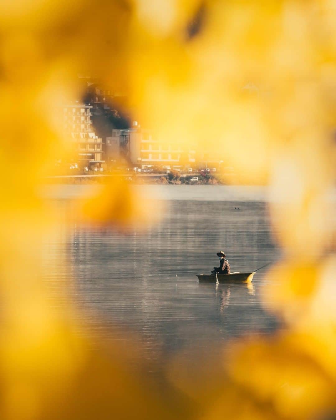 Canon Asiaのインスタグラム：「“It was at sunrise when I saw this fisherman paddling out and into the lake. It was a beautiful morning, with mist hovering over the water.As a way to add more contrast and depth into my shot, I made use of the autumn leaves present to frame my shot. Then all I had to do was to wait for the right moment to snap. Although this was only in a few seconds, it was more than enough time for me to create a wholesome photograph.” • Want more depth in your shot? Look around 👀 for interesting objects that can help to frame your shot! Get creative with a pile of leaves 🍂 or even a hole in a building 🕳️! • 📷 Image by @angelomendo shot using the Canon EOS 6D | Canon EF 70-200mm f/4L IS USM | f/9 | 1/320s | ISO 320 | 183mm  Want your photos to be featured too? Tag them with #canonasia or submit them on My Canon Story, link in bio!  #canonasia #photography #canon #canonphotography #photographytips #framing #naturephotography #autumn #igjp #Japan #travelphotography #travel」