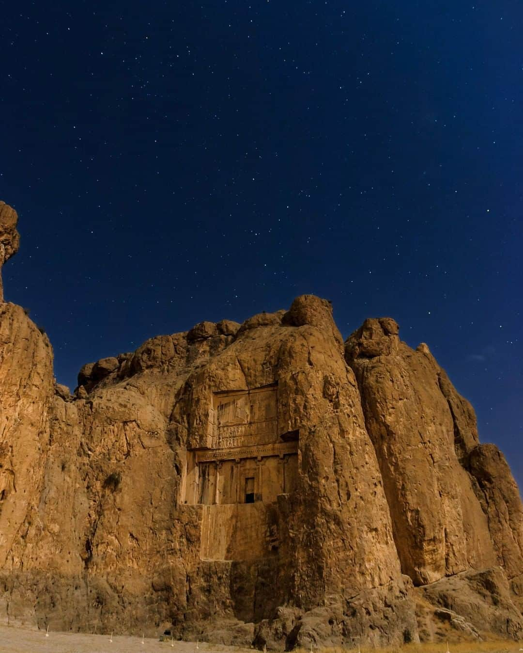 National Geographic Travelさんのインスタグラム写真 - (National Geographic TravelInstagram)「Photo by @BabakTafreshi | This massive cliff near Persepolis in southern Iran is one of the most striking archeological sites I have visited. It was even more otherworldly in this night under bright moonlight with stars of Cassiopeia shining in the sky. Known as Naqsh-e Rustam, it is home to four cross shaped tombs of ancient Persian kings, each 22 meters high, the height of a seven-story building, cut into a cliff 60 meters high. The Achaemenid Empire dates back to about 2500 year ago. It became larger than any previous empire in history, including various nations from the Eastern Europe to north of India and bordering China. #achaemenid #shiraz #naqsherostam」5月14日 16時12分 - natgeotravel