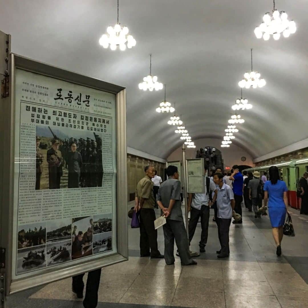 National Geographic Travelさんのインスタグラム写真 - (National Geographic TravelInstagram)「Photo by David Guttenfelder @dguttenfelder | Commuters read daily newspapers hanging on public display on the subway train platform in Pyongyang, North Korea.  Please follow me, @dguttenfelder, for an inside look at North Korea, where I have been traveling, photographing and trying to open a window on this isolated country for the past 19 years.」5月16日 4時04分 - natgeotravel