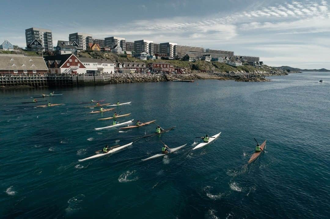 National Geographic Travelさんのインスタグラム写真 - (National Geographic TravelInstagram)「Photo by @kiliiiyuyan | In Greenland, where kayaks originate, traditional kayaking has experienced a renaissance. Just moments after the start of the men's long-distance race in the National Championships, kayak racers pull away. In the distance, Nuuk's multi-level buildings are indicators of a thriving and modern Greenlandic economy. Follow me, @kiliiiyuyan, for more from the indigenous world and beyond. #greenland #kayak #indigenous」5月18日 12時53分 - natgeotravel