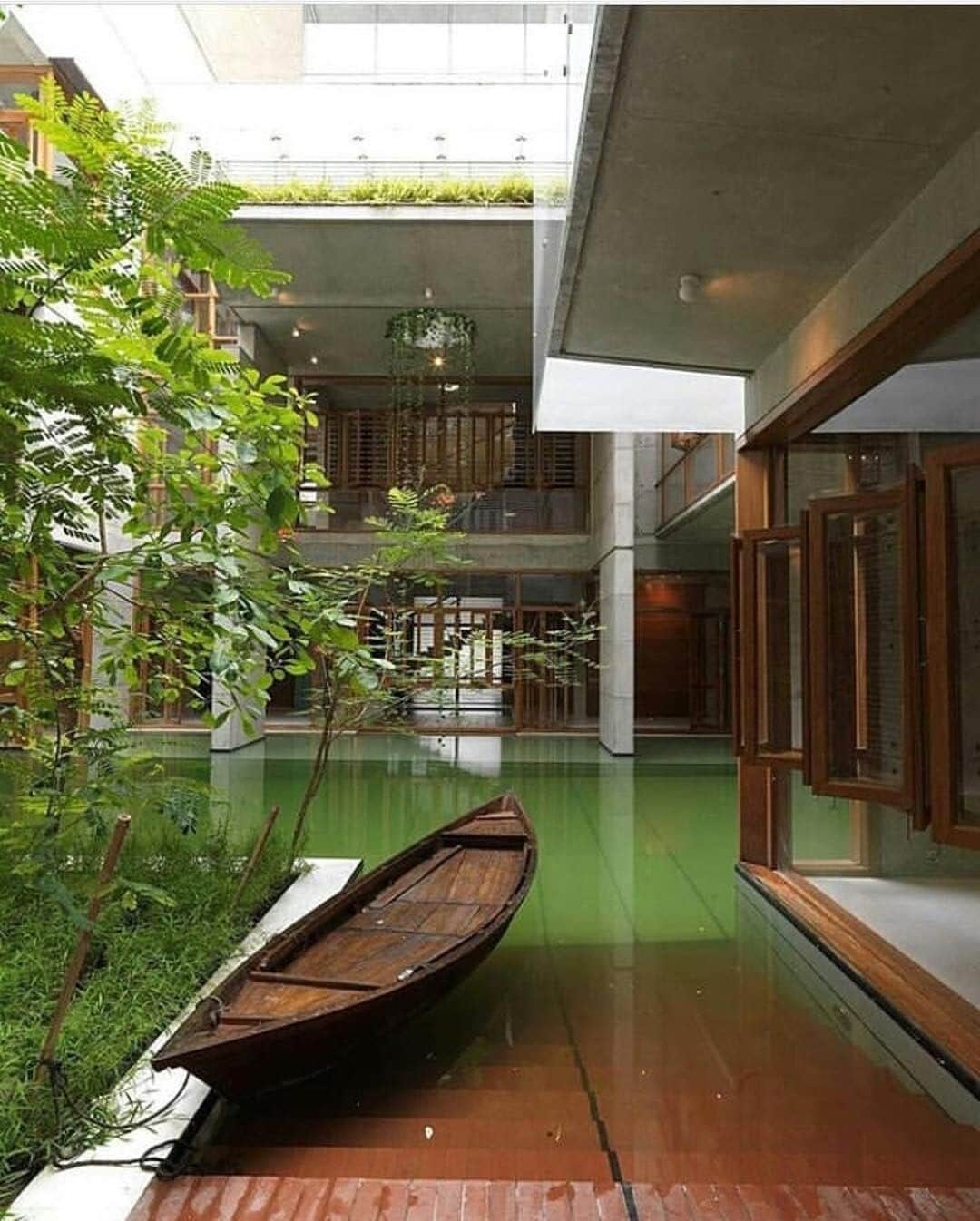ウォントのインスタグラム：「Natural elements meet urban context. Verdant and deep wood shades contrast with neutral cement tones at a residence in Dhaka, Bangladesh designed by Rafiq Azam. — #wantlesessentiels #inspiration #architecture #design」