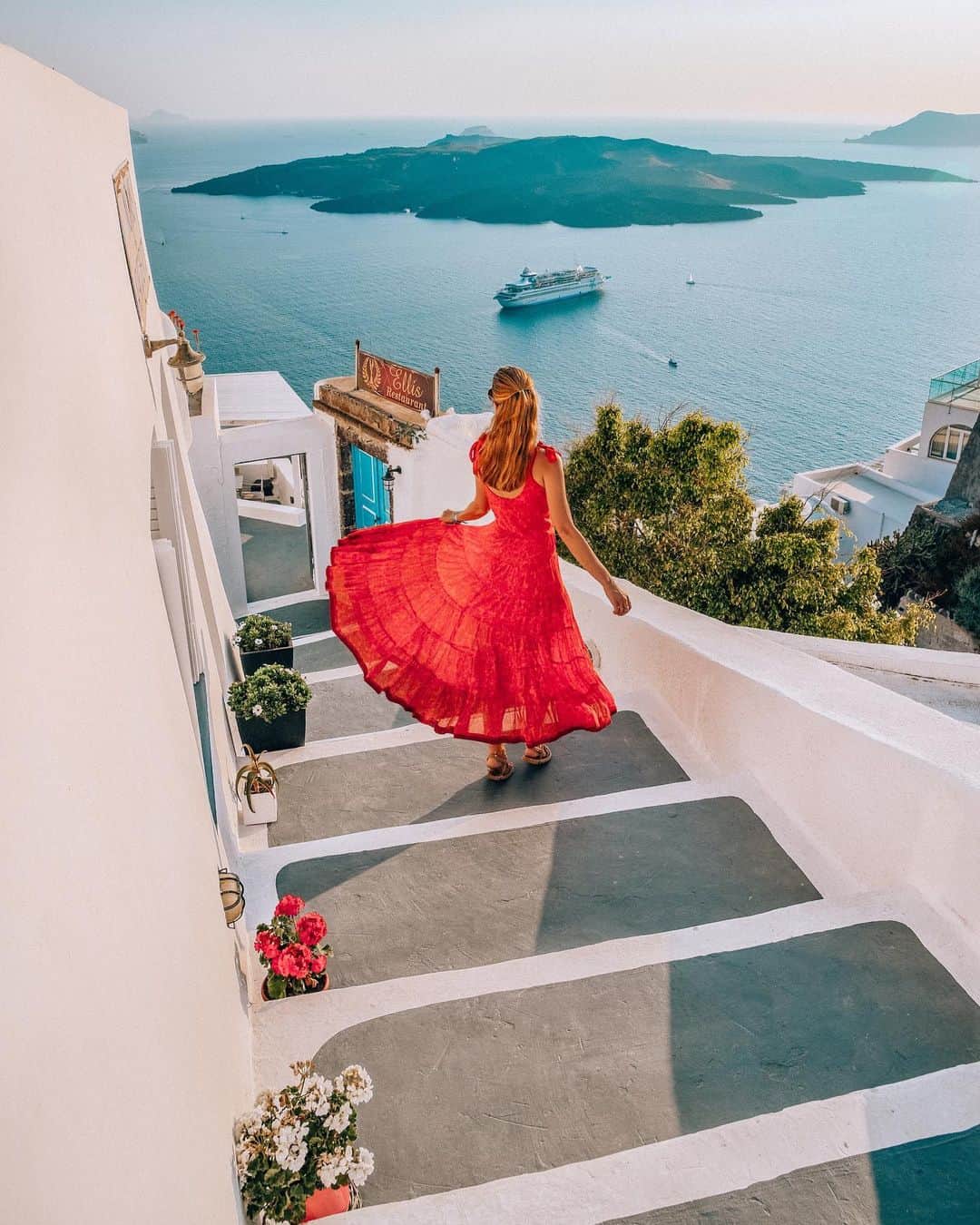 Izkizのインスタグラム：「Twirling my way around Santorini 💃🏼 The beautiful island of Santorini was the third stop on our 3 days cruise with @tatilsepeticom 💙 It’s one of my favourite places and looks even better in real life than in photos . The cruise ship anchors offshore below Thira and you can take a cable car to the top. We decided to enjoy Thira this time instead of visiting Oia like we usually do. It was much less busy but still picture perfect 😍 #tatilsebebimvar」