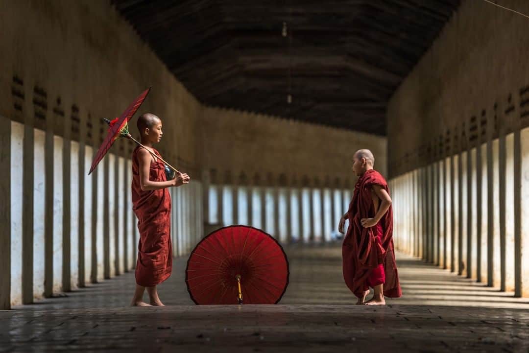 National Geographic Travelさんのインスタグラム写真 - (National Geographic TravelInstagram)「Photo by @michaelclarkphoto | Novice Buddhist monks playing around in the columns at the entrance to the Shwezigon Pagoda, near Bagan, Myanmar. This spot is a huge tourist draw and pretty much every photo workshop that comes through Myanmar stops in here and hires a few novice monks to photograph in the columns. Instead of posing the novice monks in the columns as most photographers do, I captured a few shots of them just hanging out waiting for the next tourist group of photographers to come through. #myanmar #bagan #shwezigonpagoda」5月29日 13時14分 - natgeotravel