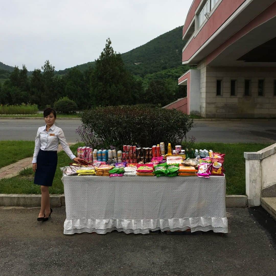 National Geographic Travelさんのインスタグラム写真 - (National Geographic TravelInstagram)「Photo by David Guttenfelder @dguttenfelder | A North Korean woman sells snacks at a roadside rest area for tourists along the highway from Pyongyang to Kaesong and the DMZ that separates the two sides of the Korean peninsula. Please follow me, @dguttenfelder, for an inside look at North Korea, where I have been traveling and photographing for the past 19 years.」5月30日 0時55分 - natgeotravel