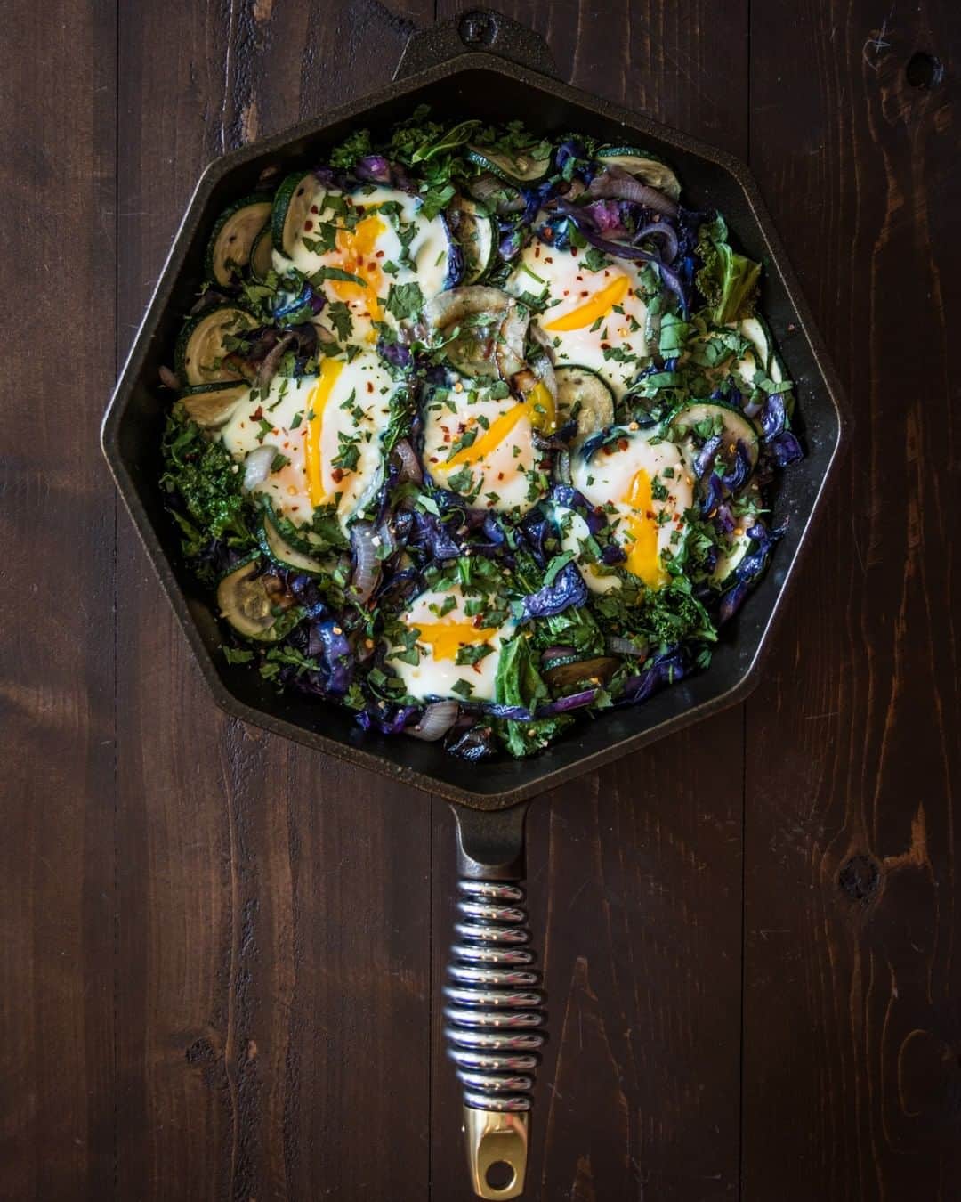 Flavorgod Seasoningsさんのインスタグラム写真 - (Flavorgod SeasoningsInstagram)「One Dish Breakfast Skillet 🍳⠀ .⠀ Ingredients:⠀ 1 zucchini, sliced⠀ 1/2 small purple cabbage, sliced⠀ 1 bunch kale, chopped⠀ 1 small onion, sliced⠀ 6 eggs, room temp if possible⠀ 1/4 tsp @flavorgod Garlic Herb Salt⠀ 1-2 tbsp cooking fat of choice⠀ Garnish:⠀ red pepper flakes⠀ cilantro, chopped⠀ .⠀ Directions:⠀ Preheat oven to 350F. Heat a large skillet over med high heat. When hot, add cooking fat (I used pork lard for extra flavor!). Add onions and cabbage first. Sauté for about 5 minutes, then add zucchini. Cook another 5 minutes or so, then add kale and garlic herb salt. Stir veggies and cook another 5 minutes. Using the back of a spoon, create 6 little wells for the eggs. Crack an egg in each well, then place skillet in oven and cook for about 7-8 minutes or until egg whites are set and turn opaque. Season with more garlic herb salt if desired. I always top mine with red pepper flakes and chopped cilantro. Serve as is, or with a side of your favorite breakfast sausage, bacon, or ham. - Pan from @finexcookware -⠀ -⠀ #food #foodie #flavorgod #seasonings #glutenfree #keto #paleo #vegan #kosher #breakfast #lunch #dinner #yummy #delicious #foodporn #mealprep ⠀」5月30日 22時00分 - flavorgod