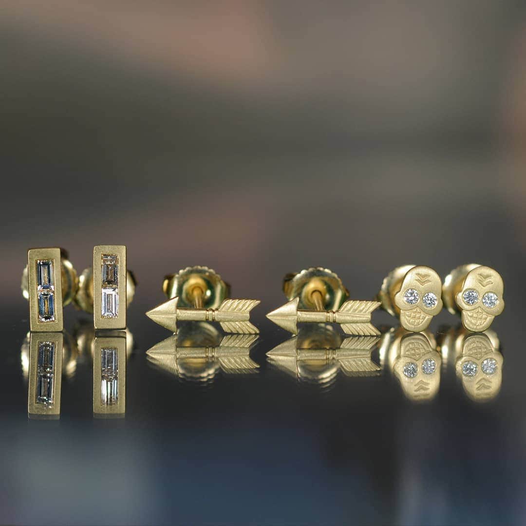 のインスタグラム：「Our 18K gold studs explore a spectrum of symbolism, from reason to abstraction. We travel back and forth between these extremes in a lifetime, and in a single day. These double baguette diamonds are brimming with possibility. They give us pause like punctuation in sacred text, while the brilliant diamond eyes of our skull studs remind us to live life fully and mindfully. Abiding by arrows the universe made to guide us, we may find a sweet spot to be active and restorative, with reason and wonder. Find the pair that speaks to you and be simply studded, every day.」
