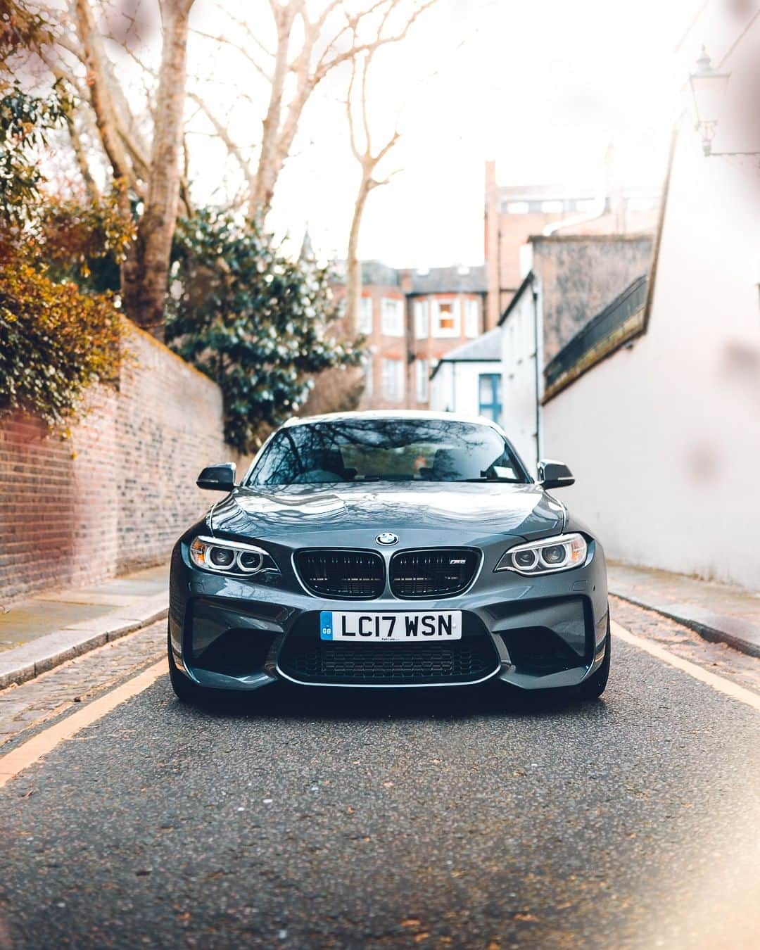 BMWのインスタグラム：「Brings energy even to the narrowest streets. The BMW M2 Coupé. #BMWrepost @sammooresphoto #BMW #M2 #BMWM __ BMW M2 Coupé: Fuel consumption in l/100 km (combined): 8.5. CO2 emissions in g/km (combined): 199. The values of fuel consumptions, CO2 emissions and energy consumptions shown were determined according to the European Regulation (EC) 715/2007 in the version applicable at the time of type approval. The figures refer to a vehicle with basic configuration in Germany and the range shown considers optional equipment and the different size of wheels and tires available on the selected model. The values of the vehicles are already based on the new WLTP regulation and are translated back into NEDC-equivalent values in order to ensure the comparison between the vehicles. [With respect to these vehicles, for vehicle related taxes or other duties based (at least inter alia) on CO2-emissions the CO2 values may differ to the values stated here.] The values of the vehicles are preliminary. The CO2 efficiency specifications are determined according to Directive 1999/94/EC and the European Regulation in its current version applicable. The values shown are based on the fuel consumption, CO2 values and energy consumptions according to the NEDC cycle for the classification. For further information about the official fuel consumption and the specific CO2 emission of new passenger cars can be taken out of the „handbook of fuel consumption, the CO2 emission and power consumption of new passenger cars“, which is available at all selling points and at https://www.dat.de/angebote/verlagsprodukte/leitfaden-kraftstoffverbrauch.html.」