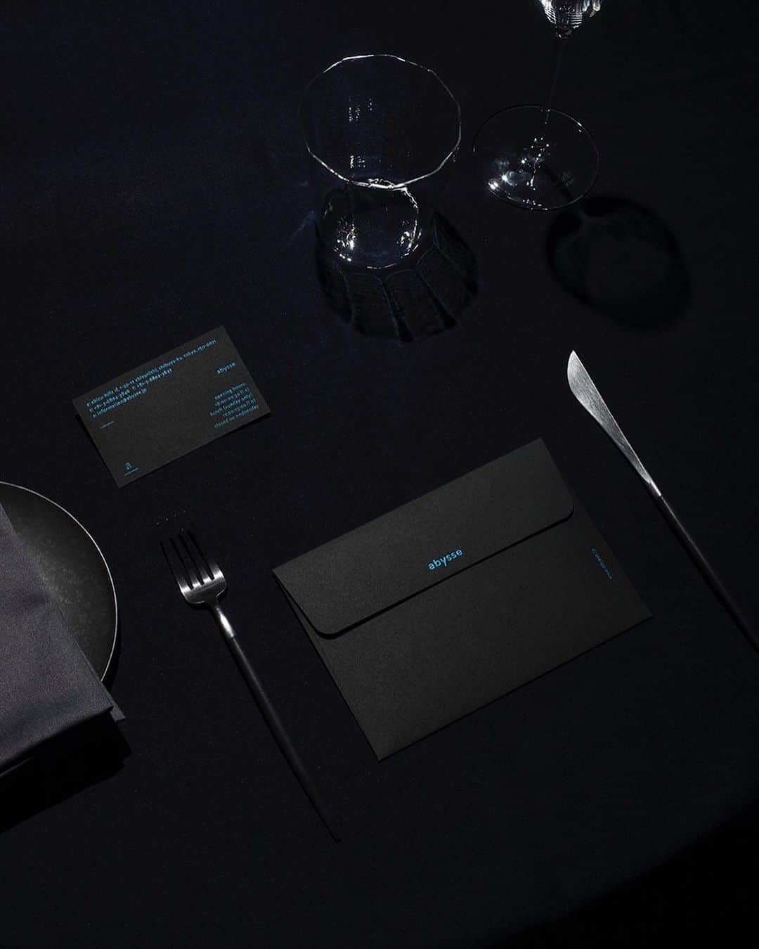 川上俊のインスタグラム：「Designs: Branding and design for modern seafood cuisine “abysse” daikanyama, tokyo by @shunkawakami and #artless Inc. - Seafood restaurant “abysse” lead by the young owner-chef Kotaro Meguro was awarded the Michelin 1-star within a year of its opening in March 2015 in Gaienmae, Tokyo. As part of their move to Daikanyama in March 2019, we were in charge of branding as well as holistic art direction and design, encompassing the logo, V.I., graphic design, signage, website, uniforms, and ambient music.  The French word “abysse”, in addition to signifying the depth of the ocean, carries the meaning “of having depth”. In creating the logomark and brand color we drew inspiration from their concept of evoking the oceanic depths and deepness of the flavor of their dishes. In the interior, the use of wood salvaged from the ocean expresses the depth of both the ocean and forest.  The menus styled like letters welcoming guests to their tables are adorned with foil stamps and signed by the chef. In order to design a complete dining experience, we carefully selected the chef uniforms in the open kitchen as well as curating the ambient music to stimulate the senses while creating a serene atmosphere.  The aim of our branding project is to express their reverence for the ocean, forest, and approach to materials, in the hopes of ushering “abysse” into the global stage.  #typography #shunkawakami」
