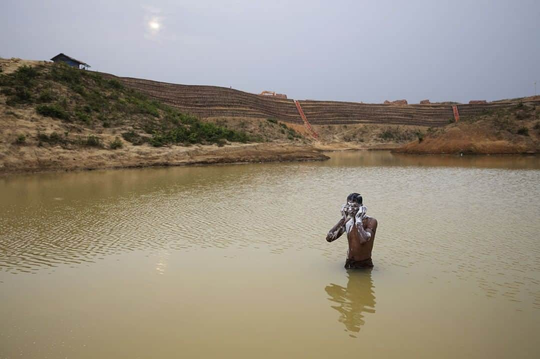 TIME Magazineさんのインスタグラム写真 - (TIME MagazineInstagram)「Nearly a million #Rohingya, a majority-­Muslim ethnic group from ­majority-Buddhist Myanmar’s western­most state of Rakhine, are stuck in #refugee camps in southeastern Bangladesh, having fled violence and persecution in large numbers in late 2017. #Bangladesh, which generously let them in, doesn’t want them to stay. The official narrative of the international community holds that the Rohingya must be allowed to go home to #Myanmar voluntarily, in safety and with dignity. Yet in reality that is not going to happen for a very long time—if ever—writes Feliz Solomon. In this photograph, a man bathes in a man-made pond near the camp where he lives. The population is settling in for the long haul. Read the full story, and see more pictures, at the link in bio. Photograph by @jamesnachtwey for TIME」6月3日 5時19分 - time