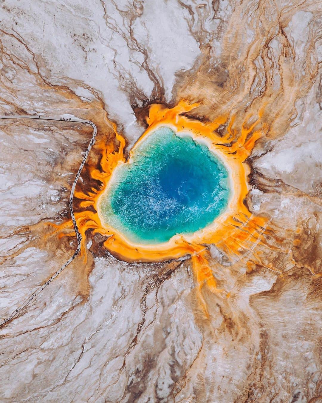 Daily Overviewさんのインスタグラム写真 - (Daily OverviewInstagram)「The Grand Prismatic Spring — located in Teton County, Wyoming, inside Yellowstone National Park — is the largest hot spring in the United States and the third largest in the world. The spring is approximately 370 feet (110 m) in diameter, 160 feet (50 m) deep, and discharges an estimated 560 gallons (2,100 L) of water per minute. Its vivid colors, which match the rainbow dispersion of white light by a prism, are caused by layers of microorganisms that live around the edges of its mineral-rich water. /// Plane photography by @chrisleipelt.photos」6月4日 1時06分 - dailyoverview