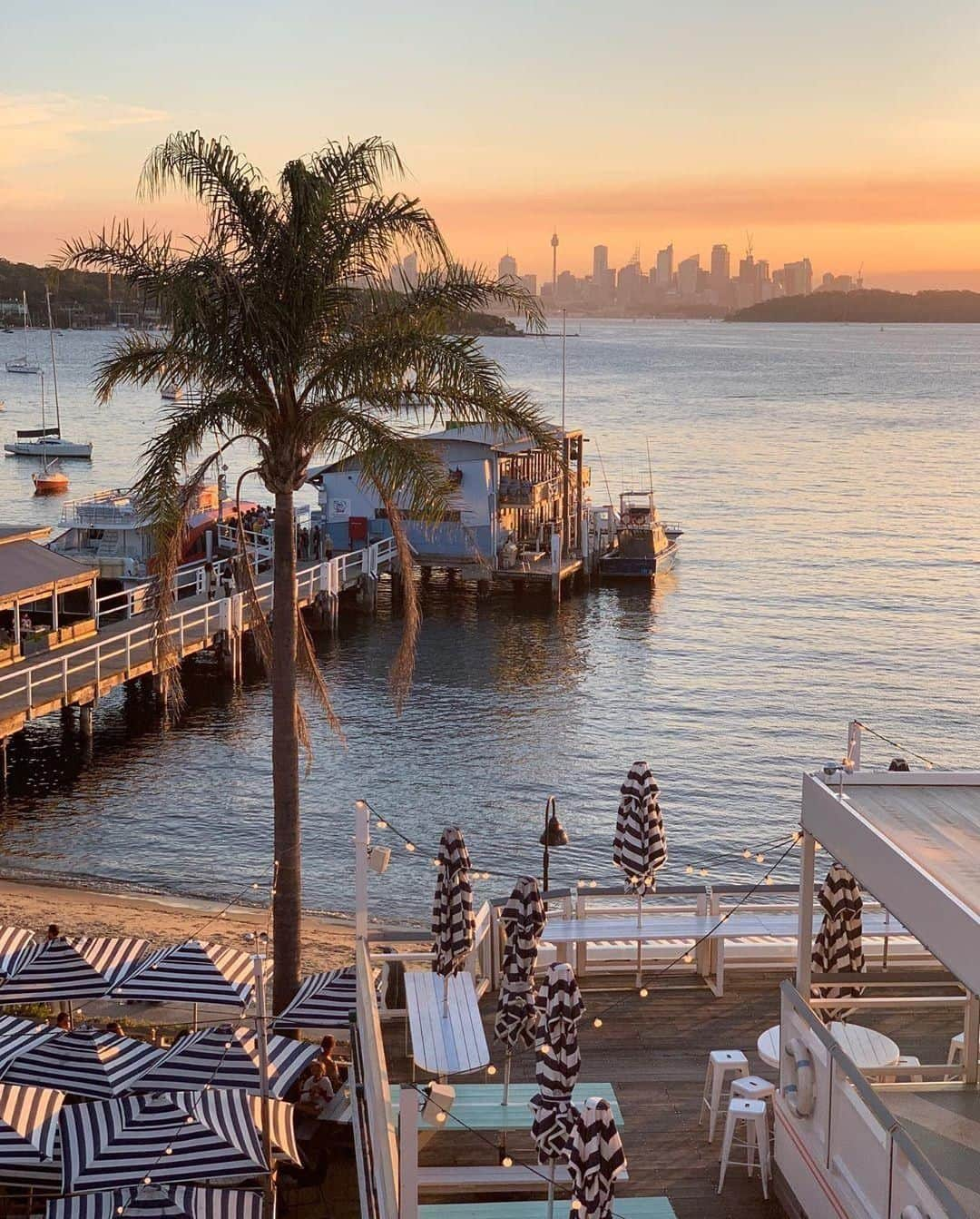 Australiaさんのインスタグラム写真 - (AustraliaInstagram)「We looked up “food with a view” in the dictionary and found this spectacular shot of @watsonsbayboutiquehotel 😉 @thexploraa thoroughly enjoyed lovely #sunset views from this popular waterfront restaurant in #WatsonsBay, and with a vantage point delivering both @sydney’s #skyline and #SydneyHarbour, we can certainly see why! Enjoy a laid-back long lunch here (treat yourself to the seafood platter), and let it flow into evening drinks before catching a ferry back into the CBD. TIP: Stay at the on-site boutique accommodation to make a weekend out of it; you’ll get to see the sunrise view in the morning too.  #seeaustralia #restaurantaustralia #newsouthwales #ilovesydney #sydneylocal #foodwithaview」6月5日 15時00分 - australia