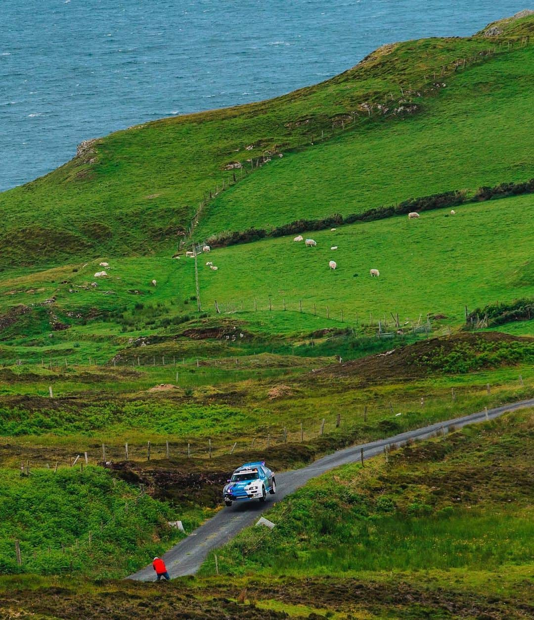 ケン・ブロックさんのインスタグラム写真 - (ケン・ブロックInstagram)「The roads here in Ireland are awesome. Both in terms of driving, as well as scenery! Case in point: this photo from testing early this week in prep for the Donegal Rally. Ocean, sheep, my Ford Escort RS Cossie V2 with all four wheels off the ground and a random rally enthusiast taking a photo of @AlexGelsomino and I in the air (btw, photographer guy… I want to get that shot!). #scenicsceneisscenic #CossieWorldTour #DonegalRally #BlockEscortCossieV2」6月22日 8時05分 - kblock43