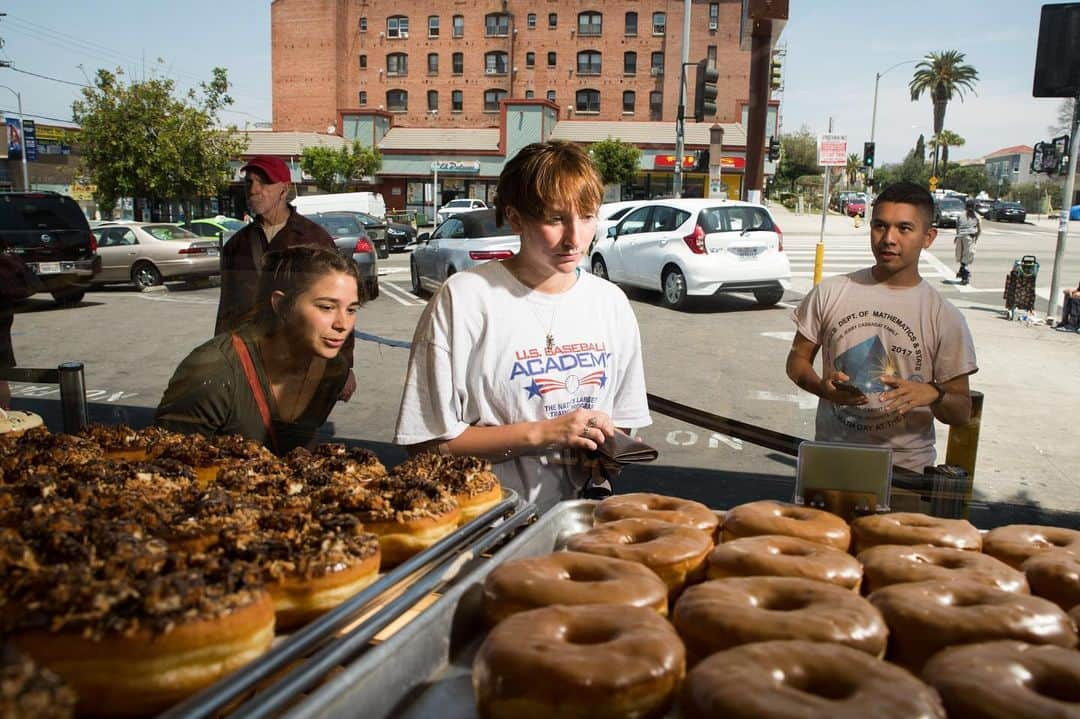 TIME Magazineさんのインスタグラム写真 - (TIME MagazineInstagram)「Colorado-based photographer Theo Stroomer's personal project on the #🍩, its history and its relation to #LosAngeles came about, simply, "because I just drove by a doughnut shop.” The rich history of immigrants arriving in and around L.A., opening doughnut shops that shaped the area, further fascinated Stroomer. Newcomers, he says, are reinventing the business model by taking over old locations and adding more visuals for #Instagram appeal. In these photographs on June 6, or #NationalDoughnutDay: Katy McAfee, left, Abigail Logan, center, and Matthew Ortega pick out doughnuts at California #Donuts; and Maria Reyes decorates unicorn doughnuts at the shop. Read more, and see more pictures, at the link in bio. Photographs by @theostroomer for TIME」6月8日 7時48分 - time