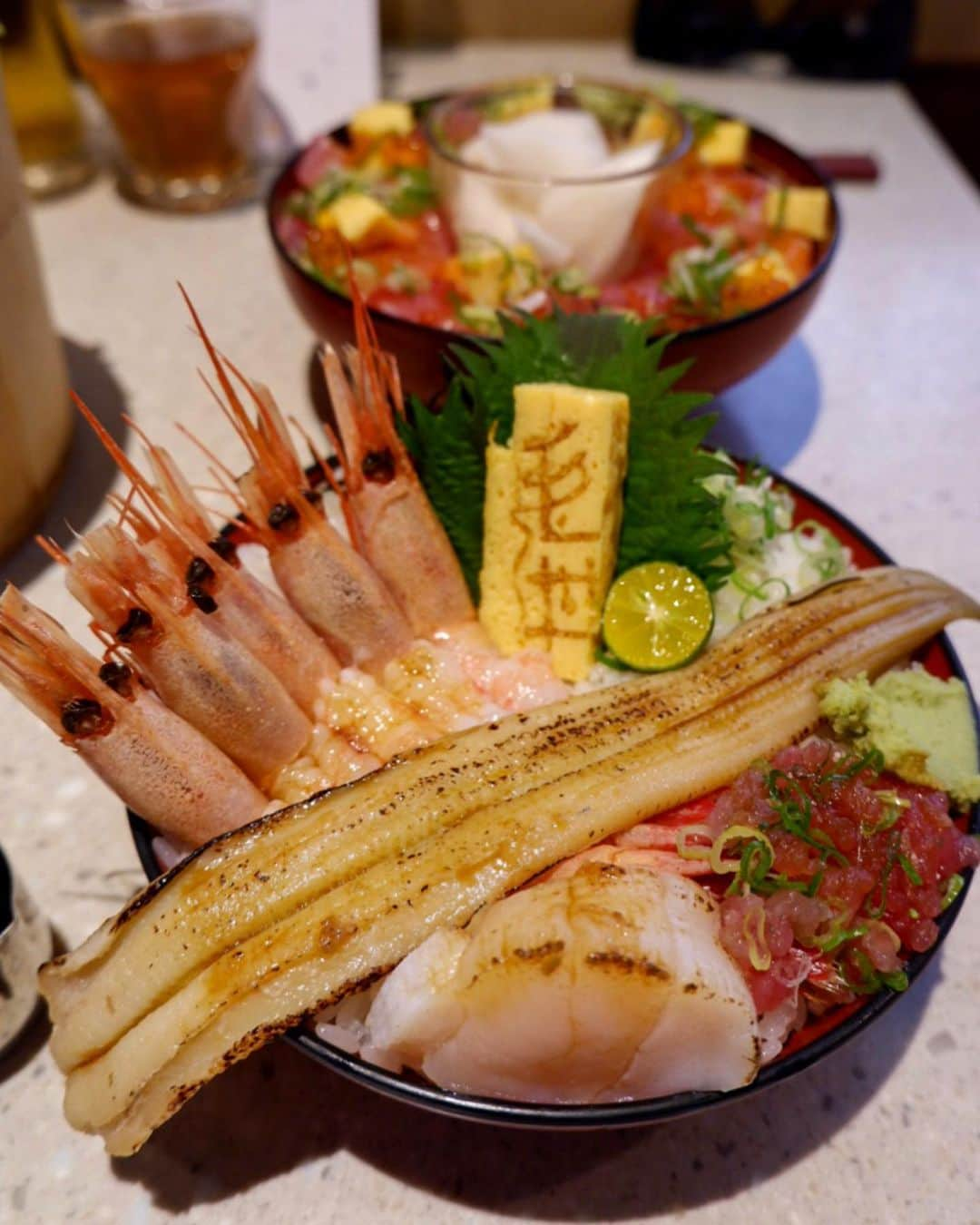 かおしさんのインスタグラム写真 - (かおしInstagram)「台北で朝ごはんを2回食べた後、新幹線で#台南 まで移動🚅 ホテルに荷物を預けて、お昼ごはんを食べに行くことに。 ・ お店は、旦那氏が見つけて、「どうしても食べたい‼︎」と言った毛丼( @maodontw )さんへ。 (マオドンなのに、どうしてもケドンと読んでしまう🤣) 到着してみると、外観からしてすごくオシャレ✨ そしてドアを開けると、店内はまるでオシャレカフェのよう✨ 丼料理のお店とは思えない♡ ・ 私は看板料理の#毛丼 、旦那氏は2段になった豪華な#步步高升丼 をオーダー。 運ばれて来た料理を見て、あまりの綺麗さに目がハートになる私たち😍 私の写真の腕が無くて、写真がイマイチなのが悔やまれるのだけれど、本当に綺麗な盛り付けなのだ✨ ・ そして、味もすごく美味しい。 毛丼には16種類の海鮮と大根(もしかしてカブ？)の甘酢漬けがのっていて、海鮮は鮮度の良さを感じるし、合間に食べる大根も食感が楽しくてイイ感じ◎ ごはんは酢飯なのだけれど、これまたちょうど良い味付けで、お箸が止まらない🥢😆 見た目で楽しめて味も美味しい料理って、本当に元気になれる〜✨ しかも、お箸だけでなくレンゲが付いているのも、食べやすくて嬉しいポイント😊 あっ‼️ 安心してください、桶は上げ底ですよ🤣 女性にもちょうど良いサイズの量でした👏 ・ お値段は木桶に入った毛丼で590元(約2100円)。 台南のローカルフードに比べたらお高めな食事だけれど、すごく美味しかったので、自分的には全然OK🙆‍♀️ また食べたいな〜🙂🧡 ・ #かおし旅 #かおし台南旅行 #台湾 #taiwan #海鮮丼 #旅グルメ #tainan #台湾グルメ #台湾旅行 #グルメ好きな人と繋がりたい #旅好きな人と繋がりたい #旅行好きな人と繋がりたい #igersjp #retrip_taiwan #retrip_gourmet #jalan_travel #jtbで旅したい #tabicoorde #repostrurubu #rurubu1st #チェジュ島行きたい #imatabiキャンペーン7 #今だからできる旅 #photo_shorttrip #タビジョ #台湾好きな人と繋がりたい」6月9日 7時08分 - cao_life