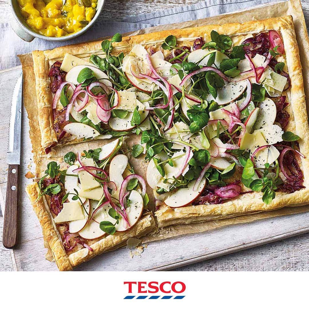 Tesco Food Officialさんのインスタグラム写真 - (Tesco Food OfficialInstagram)「It’s everything you love about a Ploughman’s... only crispy. Simply spread out the essentials (sautéed onions, Cheddar and piccalilli) onto a sheet of puff pastry and oven-bake it into a golden, picnic-perfect treat.  Ingredients 375g pack ready-rolled light puff pastry 1 tbsp olive oil 1 large red onion, thinly sliced 1½ tsp clear honey 1 tsp wholegrain mustard 1 tbsp red wine vinegar 100g extra mature Cheddar, thinly sliced handful watercress 1 small Cox apple, cored and thinly sliced piccalilli, to serve (optional)  Method 1. Preheat the oven to gas 6, 200°C, fan 180°C. Unroll the pastry, keeping it on the paper, then place on a large baking sheet. Score a border about 2.5cm from the edges, taking care not to cut all the way through. Prick inside the border all over with a fork, then bake for 15 mins. 2. Meanwhile, heat the oil in a pan over a medium heat and add all but a few slices of the onion. Add ½ tsp honey; season and fry gently for 6-8 mins until soft. Stir in the mustard; set aside. In a bowl, mix the vinegar, 1 tbsp water and the remaining honey with a pinch of salt. Add the reserved onion; set aside. 3. Press down the pastry base with the back of a spoon, then cover the base with sautéed onions; scatter over three- quarters of the cheese. Bake for 5 mins, then transfer to a serving board. Arrange the watercress, remaining cheese and the apple over the top. Drain the pickled onion and scatter over the top. Serve with the piccalilli, if using.」6月9日 18時06分 - tescofood