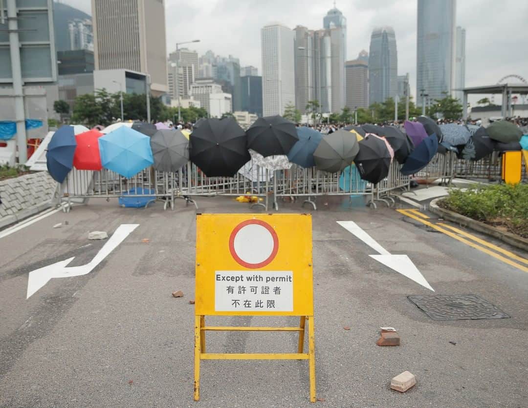 TIME Magazineさんのインスタグラム写真 - (TIME MagazineInstagram)「Umbrellas rest on barricades during a #protest against the proposed extradition bill in #HongKong on June 12. Thousands of demonstrators poured onto the streets surrounding the legislature, choking major thoroughfares and prompting the government to abruptly postpone a planned debate over the controversial legislation. The city has boiled over into massive protests over the proposed law that would, for the first time, allow fugitives to be sent to mainland #China. The fast-tracked bill has ignited fears about the former British colony’s continued autonomy—promised after its return to Chinese sovereignty in 1997—and underscores the depth of anxiety over its relationship to Beijing. Read more at the link in bio. Photograph by Thomas Peter—@reuters」6月12日 12時35分 - time