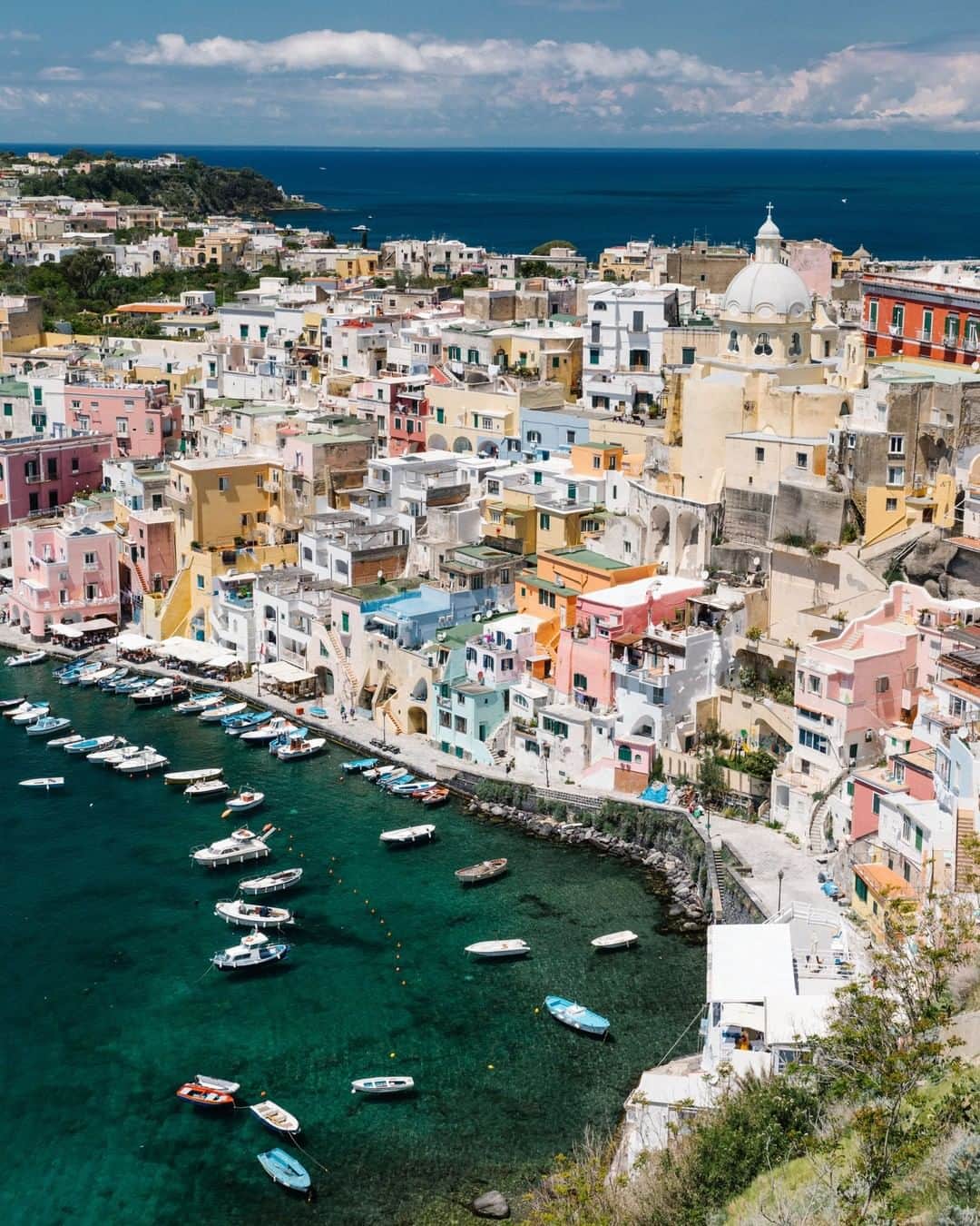 National Geographic Travelさんのインスタグラム写真 - (National Geographic TravelInstagram)「Photo by @jessicasample | Procida has the beauty of Positano and the Amalfi Coast with fewer tourists. It's just a short ferry from Naples or Ischia. When you arrive, walk from one side of the island to the other and you'll discover what if feels like to be inside a postcard.  While you wander from the ferry to Marina Corricella, you’ll find the most charming narrow streets filled with clotheslines. The buildings lining the street are the homes of actual residents as opposed to spaces filled with rentals for tourists. Grab a frozen lemon ice and soak it all in.  #procida」6月12日 22時07分 - natgeotravel