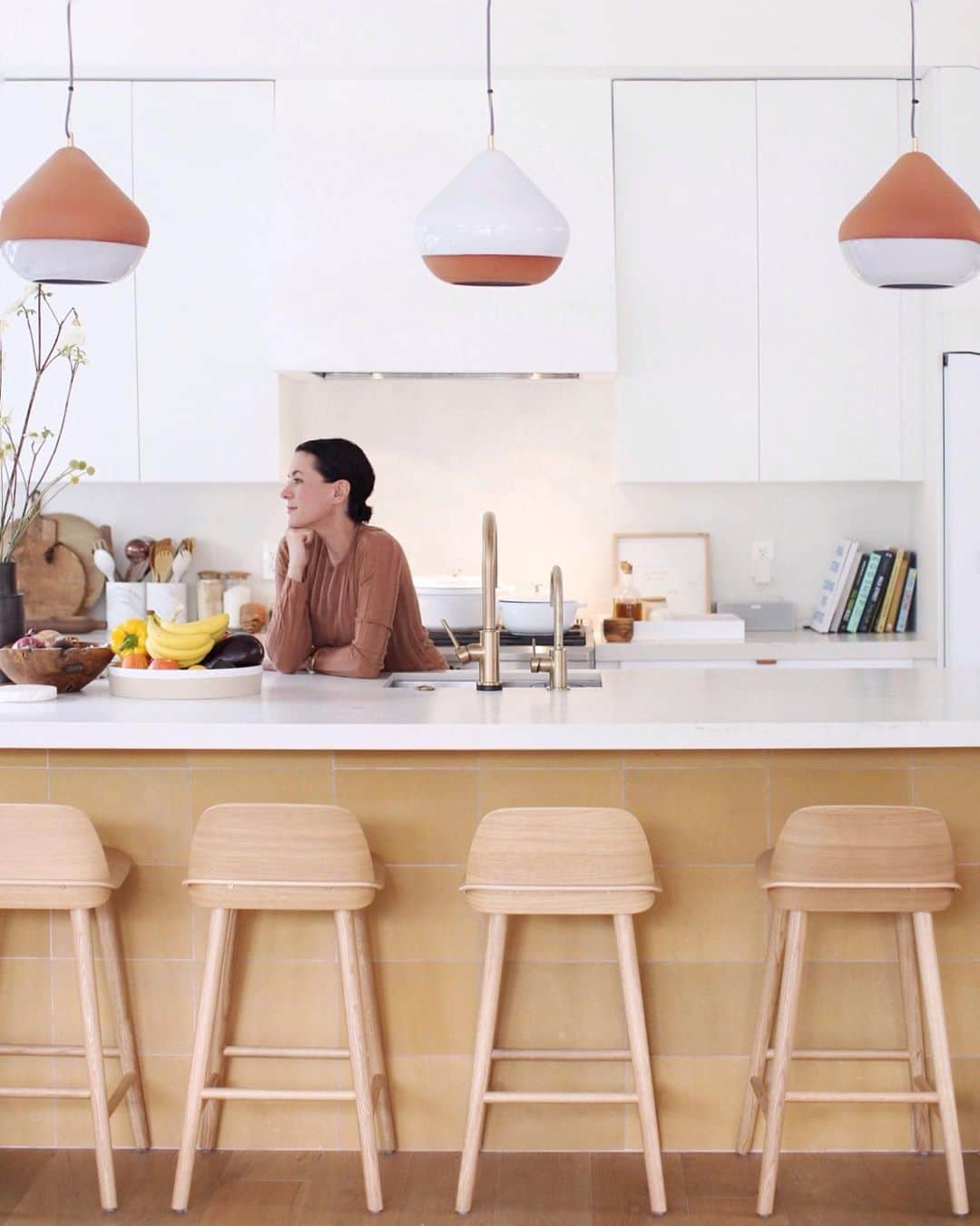 ギャランス・ドレさんのインスタグラム写真 - (ギャランス・ドレInstagram)「I was about to finish my story about fasting and talk to you about what it feels like - and what it feels like to come back home to your kitchen! And that’s when I realized I have never really showed you my kitchen!!!! . The center of my life! . Maybe you’ve seen parts of it in my stories - but here it is. It’s white and airy and big enough so I can cook with my friends and my family (hi dad!!!). It’s also a place from where you can see the living room and the dining room so there is this very happy feeling of being able to cook while people are having drinks. In other words, it’s chill. . Like every other parts of the house, @sarahshermansamuel and I didn’t make it too precious. I actually removed the marble on the island that was so stained it wasn’t funny (marble is incredibly porous, forget a lemon on it and you’re done) to replace it with some @caesarstoneus that resists all my forgetten lemons.  We used @semihandmade doors (designed by Sarah!) with @ikeausa backs. We got this beautiful white @cafeappliances stove and fridge that fit the vibe so well. Sarah rooted for the earthy tones of the back of the island with these @concretecollaborative tiles and I thank her for it. Lastly, these lamps by @handandeyestudio and stools from @designwithinreach - How cool? . Haven’t had a kitchen like that ever. Or, yes, maybe the first time my parents bought a house and they were SO PROUD because they had what we call in France an “American kitchen” 😂 (means an open kitchen)(and then you wonder why I ended up here). Until my mom realized all the kitchen smells would go in the house and decided she hated it. . Well mom, I don’t agree with you. Nothing makes me happier than smelling food around the house!!! Also what’s up, just get a good hood! . All right after all these happy materialistic considerations (but life is all about balance, isn’t it?) I’ll figure out a way to get my last chapter on fasting to you very soon. Check out my stories for an update! . Photo @lehuanoelle 🍋🥑🍏」6月15日 0時29分 - garancedore