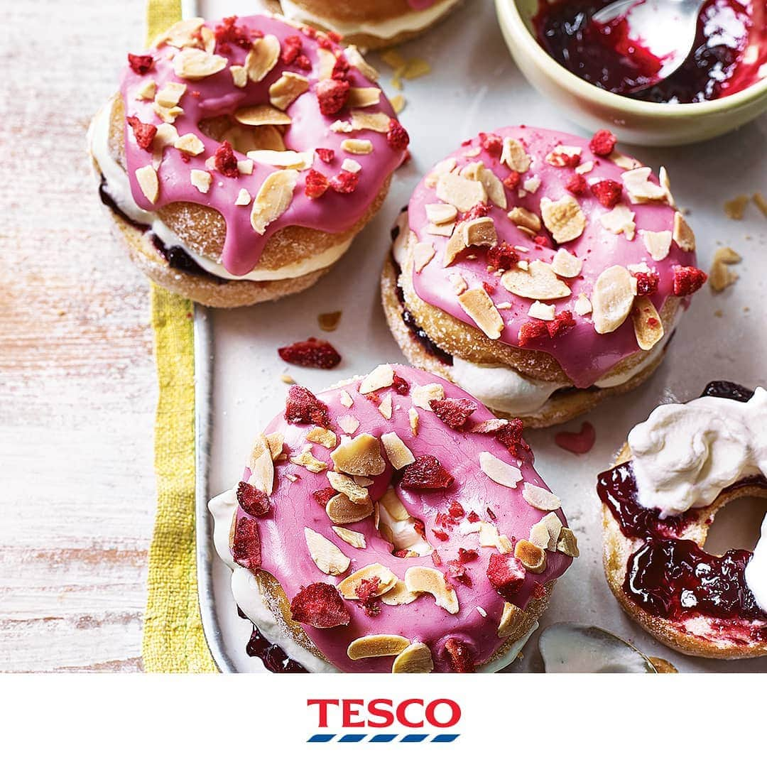 Tesco Food Officialさんのインスタグラム写真 - (Tesco Food OfficialInstagram)「What. Are. Those?  Inspired by Bakewell tarts, these store-bought doughnuts are sliced, filled with jam and cream then glazed with homemade pink icing. Super-fun, oven-free baking for the whole family.  Ingredients 7 tbsp black cherry jam 100g icing sugar, plus 1 tbsp 200ml whipping cream ¼ tsp almond extract 6 large ring doughnuts 2 tbsp toasted flaked almonds, roughly chopped (optional) 1 tbsp freeze-dried strawberries (optional)  Method 1. In a heatproof bowl, mix 1 tbsp of the jam with 1 tbsp boiling water. Sieve 100g icing sugar into a separate bowl, then sieve in the watered-down cherry jam (discarding any chunks of fruit). Stir together and add 1-1½ tsp water until you have a smooth but relatively thick icing that holds its shape; set aside.  2. Put the cream in a separate mixing bowl. Add 1 tbsp icing sugar, a pinch of salt and the almond extract to taste, stirring in a few drops at a time, then whisk to soft peaks. 3. Halve the doughnuts and spread the icing over the tops with a teaspoon, then scatter with the almonds and freeze-dried strawberries, if you like. Spread the cut-side of the bottom halves with 1 tbsp jam each, then spoon over the almond cream. Carefully top with the iced halves to serve.」6月15日 18時04分 - tescofood