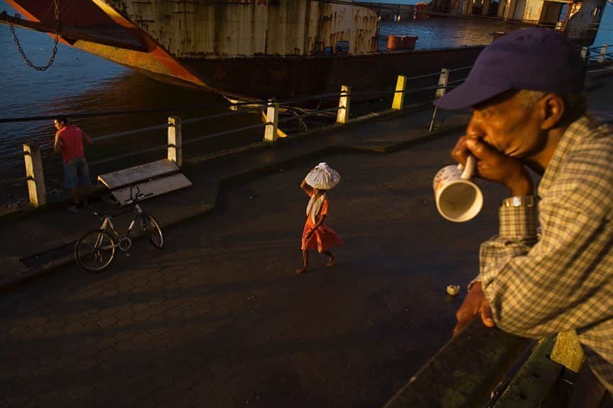 thephotosocietyさんのインスタグラム写真 - (thephotosocietyInstagram)「Photo by Ivan Kashinsky @ivankphoto | In early morning, a man stares out over the Cayapas River as a woman walks on the street below in the Ecuadorian province of Esmeraldas. This photo was part of book project, in which Karla Gachet (@kchete77) and I traveled from the Equator to the southern tip of South America. @runa_photos, @panospicutres, @natgeo, #runaflirts」6月16日 3時32分 - thephotosociety