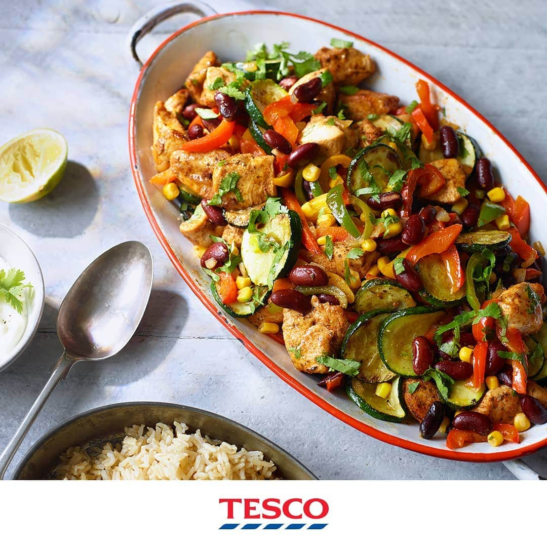 Tesco Food Officialさんのインスタグラム写真 - (Tesco Food OfficialInstagram)「Ready to shake Sunday dinner up? This Tex-Mex inspired dish is all about big flavours, brilliant colours and keeping things easy with a few grab-and-go items from the freezer aisle.  Ingredients 580g chicken breast, cut into bite-sized pieces 2 tbsp olive oil 2 tbsp Texan BBQ seasoning 100g frozen diced onions 2 garlic cloves, crushed 250g frozen sliced mixed peppers 3 courgettes, trimmed and finely sliced 400g tin kidney beans, drained and rinsed 200g tin sweetcorn, drained and rinsed 1 lime, juiced, plus extra wedges to serve (optional) 2 tbsp frozen coriander cooked brown rice and soured cream, to serve (optional)  Method Toss the chicken with half the olive oil and the BBQ seasoning. Put a large heavy-based pan over a medium heat and add the chicken (you may need to cook in batches). Fry for 6-8 mins until golden and cooked through. Remove with a slotted spoon and set aside. Heat the remaining oil in the pan. Add the onion and cook for 10 mins until soft. Add the garlic, peppers and courgettes and cook for 10 mins, stirring regularly, until the veg is softened. Return the chicken to the pan along with the kidney beans and sweetcorn. Increase the heat for a few mins, stirring regularly until everything is mixed through and piping hot. Stir in the lime juice and coriander. Serve with extra lime wedges, cooked brown rice and a spoonful of soured cream, if you like.」6月16日 18時03分 - tescofood