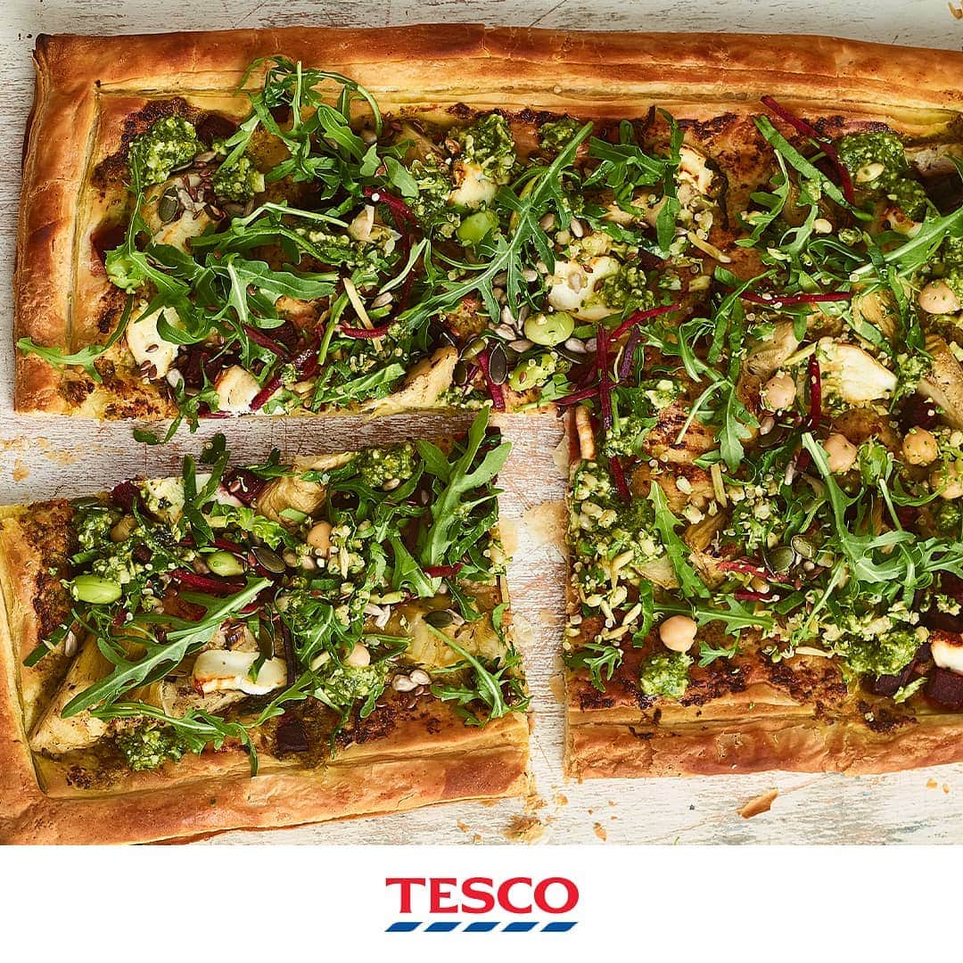 Tesco Food Officialさんのインスタグラム写真 - (Tesco Food OfficialInstagram)「If you think about it, a savoury tart is kind of like a pastry pizza? Simply take a puff pastry base, add delicious store-bought toppings then VOILA! A crispy, #MeatFree artichoke and beetroot tart like this.  Ingredients 375g pack Ready Rolled Lighter Puff Pastry 2 tbsp Tesco Finest Basil Pesto 140g pack Chargrilled Artichokes 260g pack Goat's Cheese & Beetroot Salad 2 tbsp Toasted 3 Seed Mix  Method Preheat the oven to gas 6, 200°C, fan 180°C. Unroll a 375g pack Ready Rolled Lighter Puff Pastry on its paper and place on a baking sheet. Use a sharp knife to score a 2cm border, then prick the centre all over with a fork. Brush 2 tbsp Tesco Finest Basil Pesto within the border, then add a 140g pack Chargrilled Artichokes along with the beetroot and cheese (crumbled) from a 260g pack Goat's Cheese & Beetroot Salad. Bake for 25-30 mins until the pastry is golden. Top with half the rocket and grain mix from the salad pot. Drizzle over 2 tbsp pesto and scatter with 2 tbsp Toasted 3 Seed Mix. Toss the remaining rocket and grains with the salad pot dressing and serve alongside.」6月17日 21時27分 - tescofood