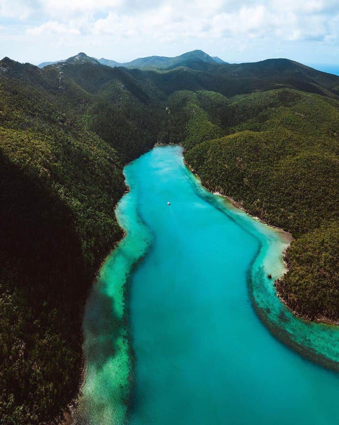 Australiaさんのインスタグラム写真 - (AustraliaInstagram)「Follow the blue carpet for @whitsundaysqld’s best hidden gems 💙 @reubennutt captured this gorgeous @queensland scenery while flying over #NaraInlet with @helireef, which is a protected anchorage on #HookIsland with significant Indigenous history. The Ngaro Indigenous people have fished and hunted in the #Whitsundays islands for over 8,000 years, and you can find the Ngaro Aboriginal cultural site that tells their stories in the cave at the end of the inlet. Charter a boat or kayak to the island and follow the walking trail to the once-hidden cave to immerse yourself in the cultural stories of the site. #seeaustralia #thisisqueensland #lovewhitsundays #viewfromabove #gbrmarinepark」6月22日 15時51分 - australia