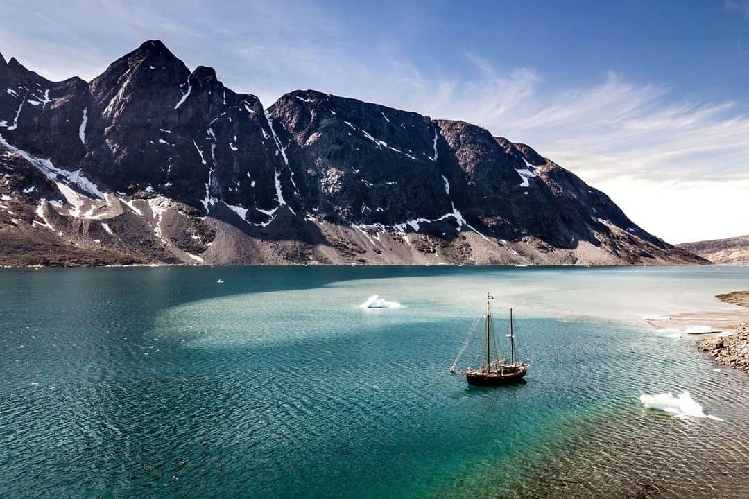 National Geographic Travelさんのインスタグラム写真 - (National Geographic TravelInstagram)「Photo by @MartinEdstrom | While exploring Greenland, the Aurora Arktika anchors in a calm fjord beside icebergs its own size. To explore the fjords and hidden islands of Eastern Greenland, you have to get your timing right. All of the eastern side is covered in a band of ice for most of the year. Only during a few months in summer does the ice recede enough for a boat to get through–meaning that the few people who live here are shut off from the world more often than not. Follow me, @MartinEdstrom, for more images of remote exploration. #greenland」6月23日 10時03分 - natgeotravel