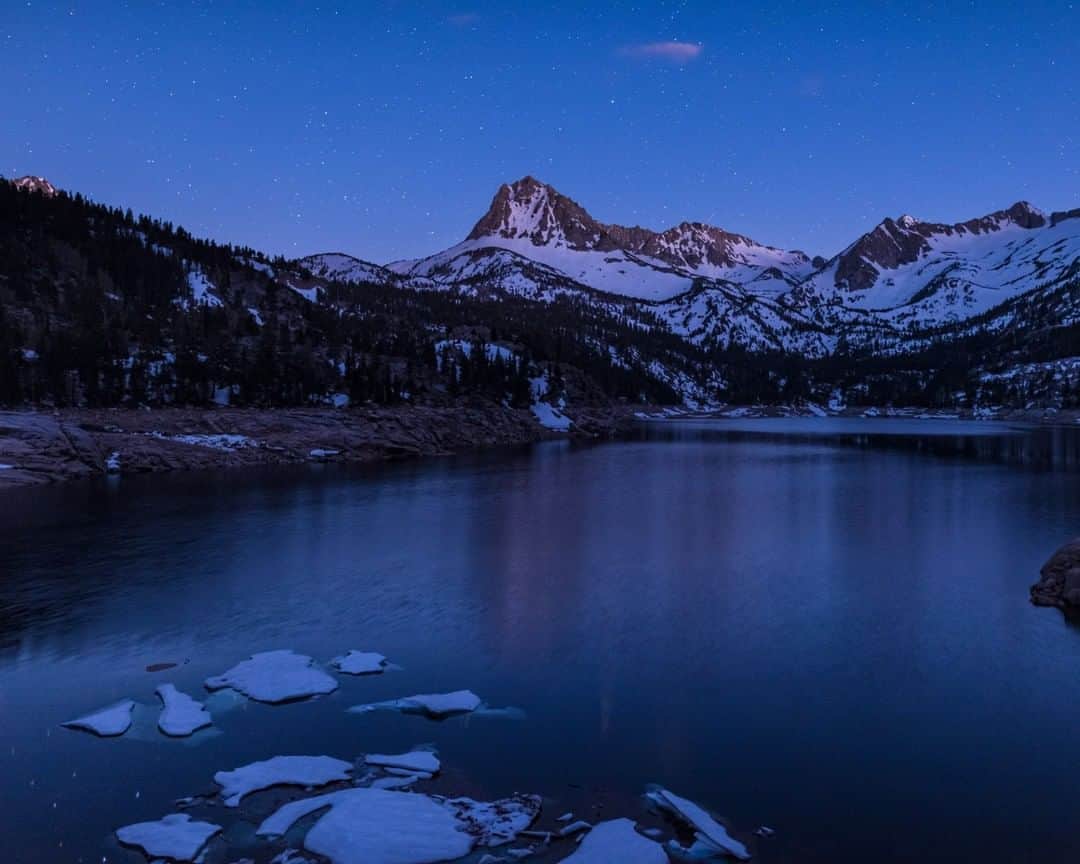 National Geographic Travelさんのインスタグラム写真 - (National Geographic TravelInstagram)「Photo by @BabakTafreshi | Last week I was standing at the shore of a 10,000 ft (3050 m) high lake in the Sierra Nevada Mountains in California. It was a surreal view was emerging in the evening twilight with the last remaining ice wondering in the lake. Far from city lights an ocean of stars was about to appear above the mountains. Explore more of The World at Night photography with me @babaktafreshi. #saveournightsky #twanight #sierra #astrophotography」6月23日 22時12分 - natgeotravel