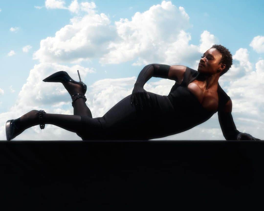 のインスタグラム：「Beau Gandiwa, power lifting world champion, personal trainer and health coach based in Bristol, for Mugler Resort 2020. - Beau wears a black tech sculpting dress, black nail rings over black sheer gloves and matching hosiery paired with black patent platform pumps. - Creative Director @cadwallader  Styling @alex_jordan_harrington  Photography @arnaudlajeunie  Casting @julialangecasting  Hair @jondefranc  Make up @christinecorbel  Movement @jordandrobson  Production @kitten_production  Model @bguns_23 #mugler」