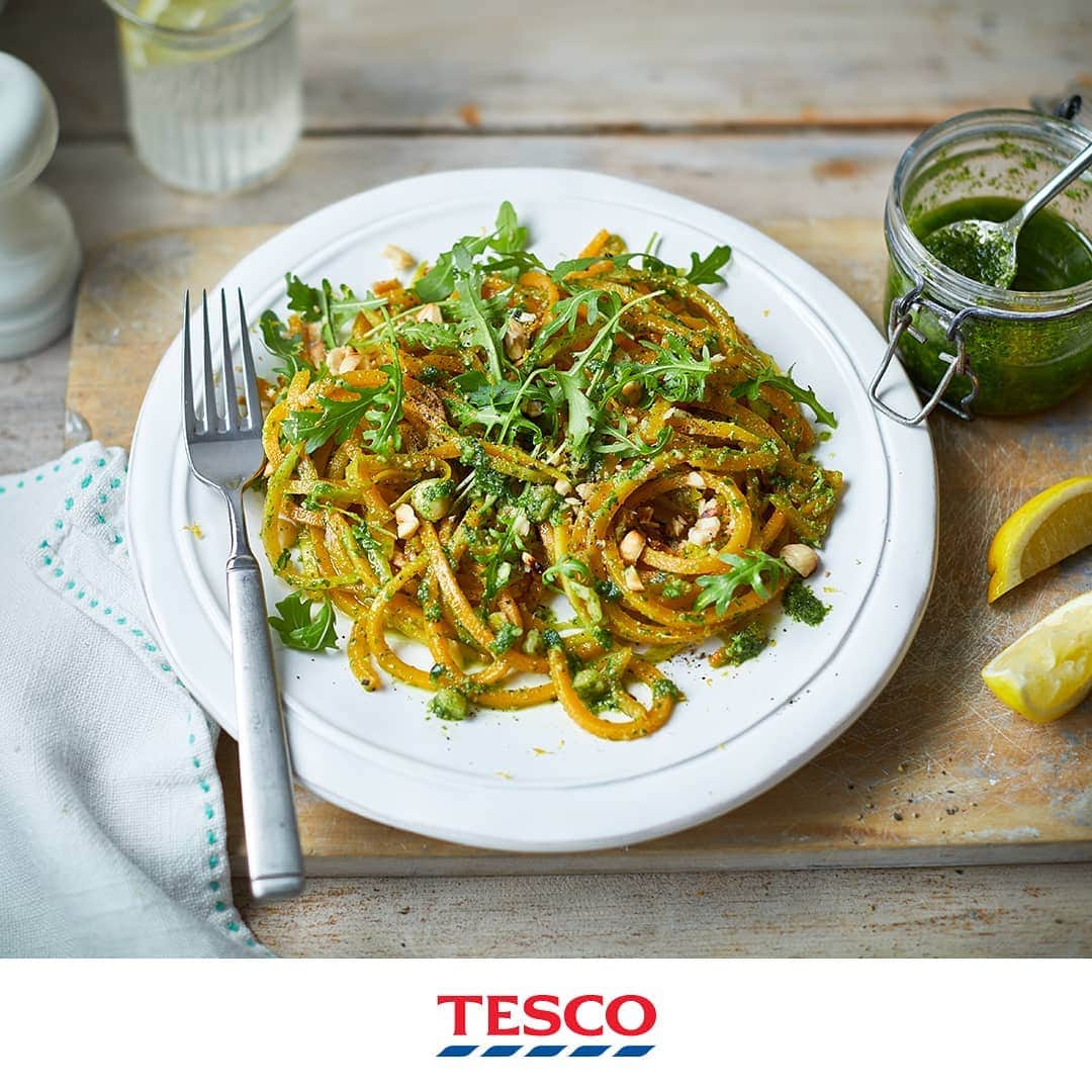 Tesco Food Officialさんのインスタグラム写真 - (Tesco Food OfficialInstagram)「Look closely. This ingenious bowl of spaghetti has swapped regular pasta for al dente ribbons of butternut squash - making it one perfect (and #Vegan friendly) #MeatFreeMonday.  Ingredients 40g hazelnuts, toasted and roughly chopped 2 garlic cloves, finely chopped 70g bag wild rocket 155ml extra-virgin olive oil ½ lemon, finely zested and juiced, plus extra wedges to serve 1 large butternut squash, peeled, cut into quarters lengthways and deseeded  Method Put 25g hazelnuts, half the garlic and 50g rocket in a food processor and pulse a few times until roughly chopped. Add 125ml oil and the lemon juice then blend again until combined but not completely smooth – you want a pesto with a little bit of texture. Season to taste and set aside. Use a spiralizer to cut the squash quarters into thin ribbons (depending on the size of your spiralizer you may need to cut the squash into thinner wedges). If you don’t have a spiralizer, you can cut the squash into thin wedges then use a vegetable peeler to peel off ribbons. Heat the remaining oil in a large, wide pan, then add the squash ribbons and sauté for 2-3 mins – you may need to do this in batches. Add the remaining garlic and a splash of water to help the squash steam gently. Cook for 2 mins, trying not to stir too much as the squash may break up. Stir most of the rocket pesto into the pan (reserving some to serve) so that it just coats the squash and heats through. Divide the squash spaghetti between plates and top with the remaining rocket leaves, chopped hazelnuts and grated lemon zest. Drizzle over the remaining pesto and serve with a lemon wedge on the side to squeeze over.」6月24日 21時08分 - tescofood