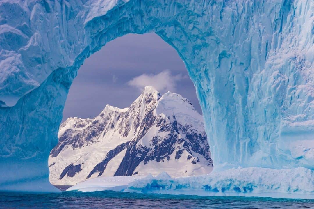National Geographic Travelさんのインスタグラム写真 - (National Geographic TravelInstagram)「Photograph by @PaulNicklen | A 3000-foot mountain along the Antarctic peninsula rises from the sea. What else could you want in a photo besides a large iceberg with a perfect arch to frame it? Follow me, @PaulNicklen, to see a lot more coverage on the fragilities of this changing seascape.  #naturesgifts #love #beauty #ice #iceberg」6月25日 22時11分 - natgeotravel