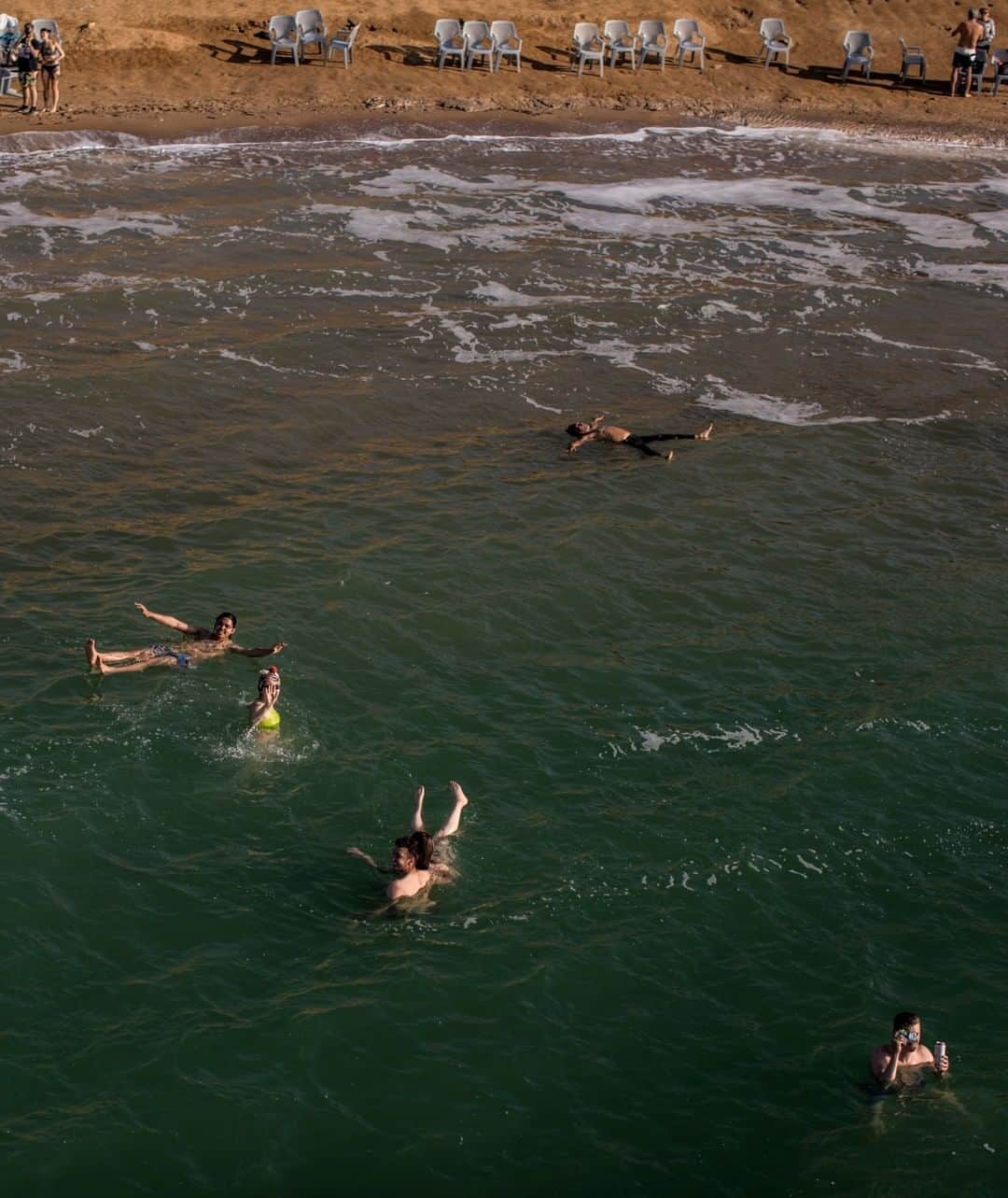 National Geographic Travelさんのインスタグラム写真 - (National Geographic TravelInstagram)「Photo by Muhammed Muheisen @mmuheisen | People enjoy floating in the Dead Sea in Jordan. For more photos and videos from different parts of the world, follow me, @mmuheisen. #deadsea #jordan」7月1日 7時01分 - natgeotravel