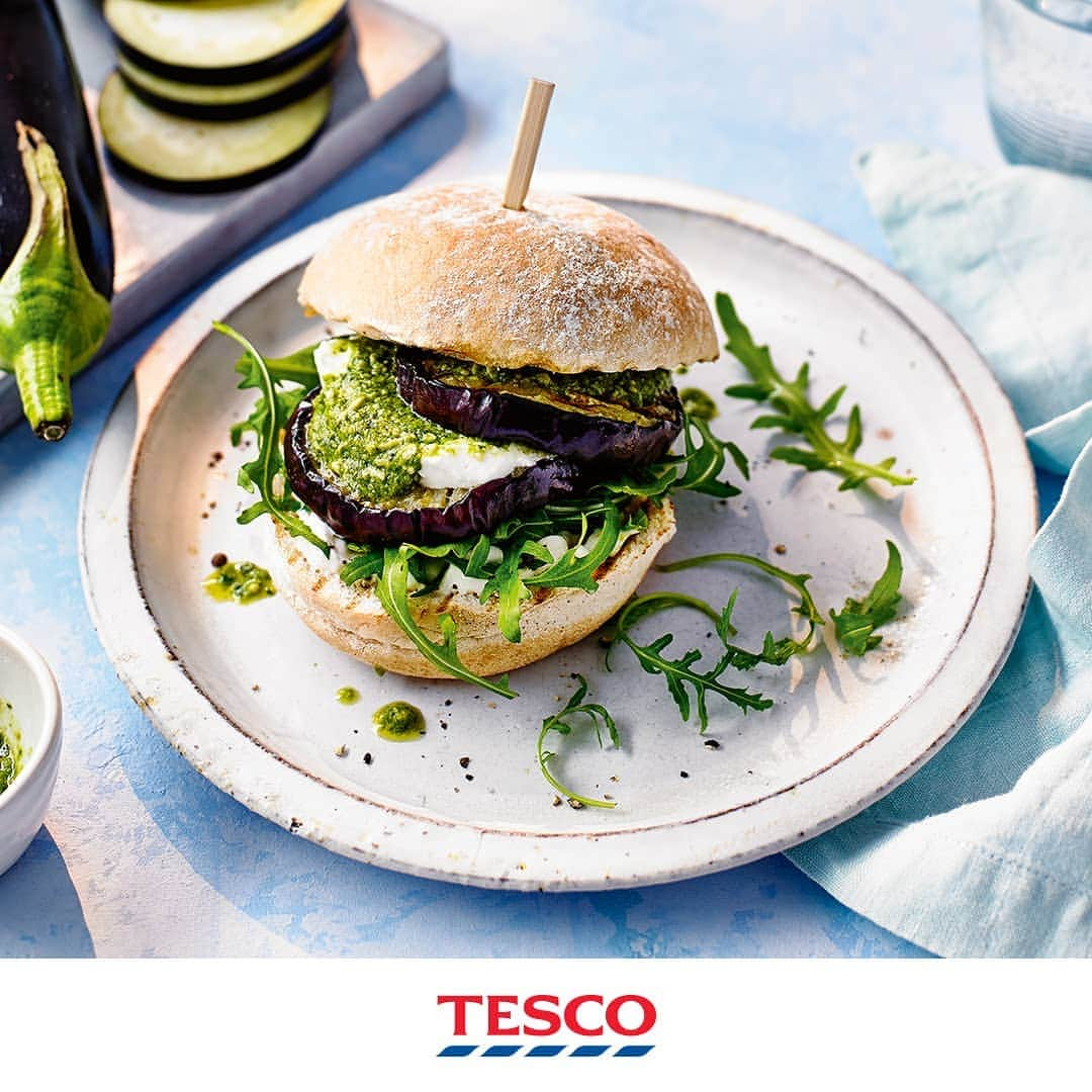 Tesco Food Officialさんのインスタグラム写真 - (Tesco Food OfficialInstagram)「Yes you can fire up the BBQ on a Monday - it’s summer! This lighter, brighter #MeatFree burger will be a fantastic, flame-grilled start to your week - zesty pesto, thick aubergine steaks and dollop of goats cheese for good measure.  Ingredients 1 large or 2 small aubergines, washed, trimmed and cut into 8 x 1.5cm rounds 1 tbsp olive oil 65g Tesco Finest basil pesto ½ lemon, juiced 4 small bread rolls, halved 4 tbsp light mayonnaise 50g rocket 75g soft goat’s cheese  Method Heat a griddle pan over a high heat until hot. Brush both sides of the aubergine slices with oil; season. Griddle in batches for 6-8 mins each side until really soft, golden and charred in places. Whisk the pesto with the lemon juice to make a spoonable dressing. Toast the bun halves in the griddle pan. Spread the mayonnaise over the bases, then add rocket. Top 4 of the griddled aubergine slices with goat's cheese and 1 tbsp of the pesto dressing. Sandwich with another aubergine slice, then pile them into the buns and spoon over more dressing. Finish with the bun lids, securing with a wooden skewer, if you like.」7月1日 21時06分 - tescofood