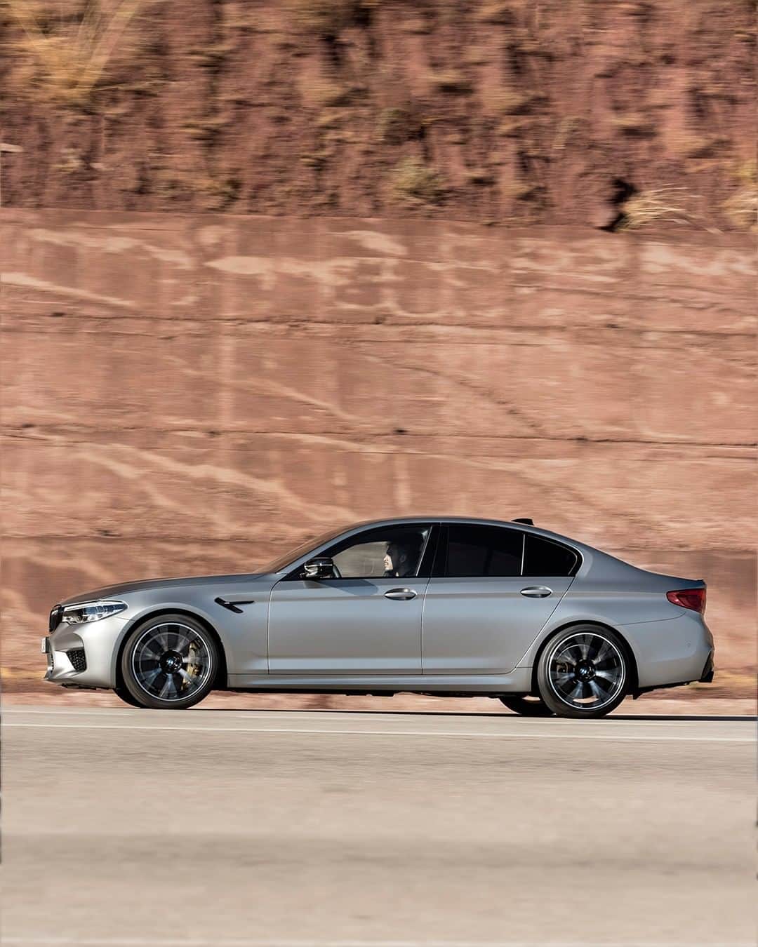BMWのインスタグラム：「On the move all the time. The BMW M5 Competition. #TheM5 #BMW #M5 #BMWM __ BMW M5 Competition: Fuel consumption in l/100 km (combined): 10.8 - 10.7. CO2 emissions in g/km (combined): 246 - 243. The values of fuel consumptions, CO2 emissions and energy consumptions shown were determined according to the European Regulation (EC) 715/2007 in the version applicable at the time of type approval. The figures refer to a vehicle with basic configuration in Germany and the range shown considers optional equipment and the different size of wheels and tires available on the selected model. The values of the vehicles are already based on the new WLTP regulation and are translated back into NEDC-equivalent values in order to ensure the comparison between the vehicles. [With respect to these vehicles, for vehicle related taxes or other duties based (at least inter alia) on CO2-emissions the CO2 values may differ to the values stated here.] The CO2 efficiency specifications are determined according to Directive 1999/94/EC and the European Regulation in its current version applicable. The values shown are based on the fuel consumption, CO2 values and energy consumptions according to the NEDC cycle for the classification. For further information about the official fuel consumption and the specific CO2 emission of new passenger cars can be taken out of the „handbook of fuel consumption, the CO2 emission and power consumption of new passenger cars“, which is available at all selling points and at https://www.dat.de/angebote/verlagsprodukte/leitfaden-kraftstoffverbrauch.html.」