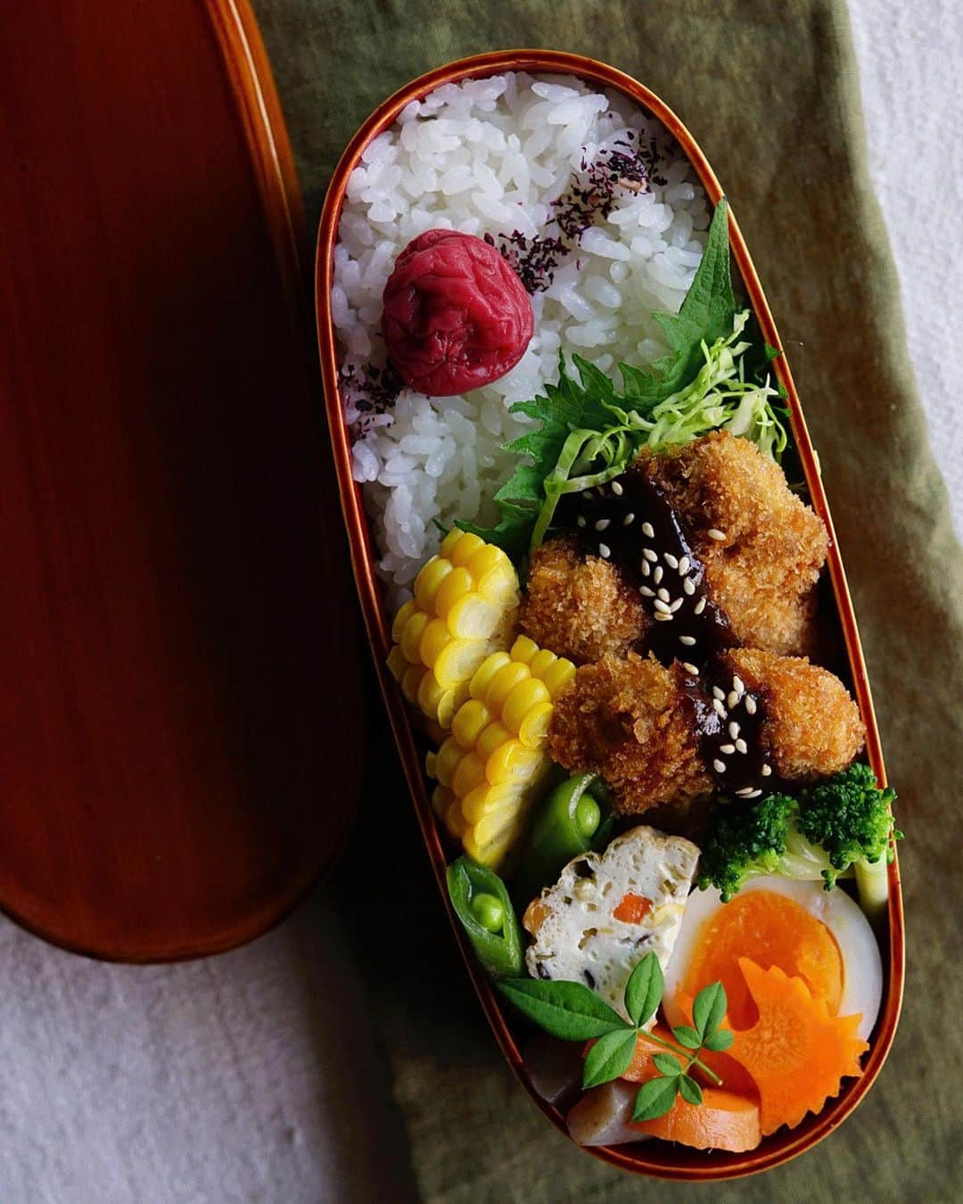Ryoko Yunokiのインスタグラム：「+ + + Pork cutlet bento/豚カツ弁当 . *rice and umeboshi *pork cutlet with shredded cabbage *steamed sweet corn and broccoli *hard-boiled egg *dashi-simmered gammo,konnyaku, carrot and snap peas . ＊ごはんと梅干し ＊豚カツとキャベツの千切り ＊蒸しトウモロコシ、ブロッコリー ＊ゆで卵 ＊がんも、蒟蒻、人参、スナップエンドウの出汁煮 . . This breaded pork and shredded cabbage are my favorite combination. For this shredded cabbage, I usually salt it, let it sit for a while and pat dry with paper towel. + + + #丸の内弁当 #f52grams #曲げわっぱ #春慶塗 #柏屋常左衛門商店 #ひのき曲げ物」