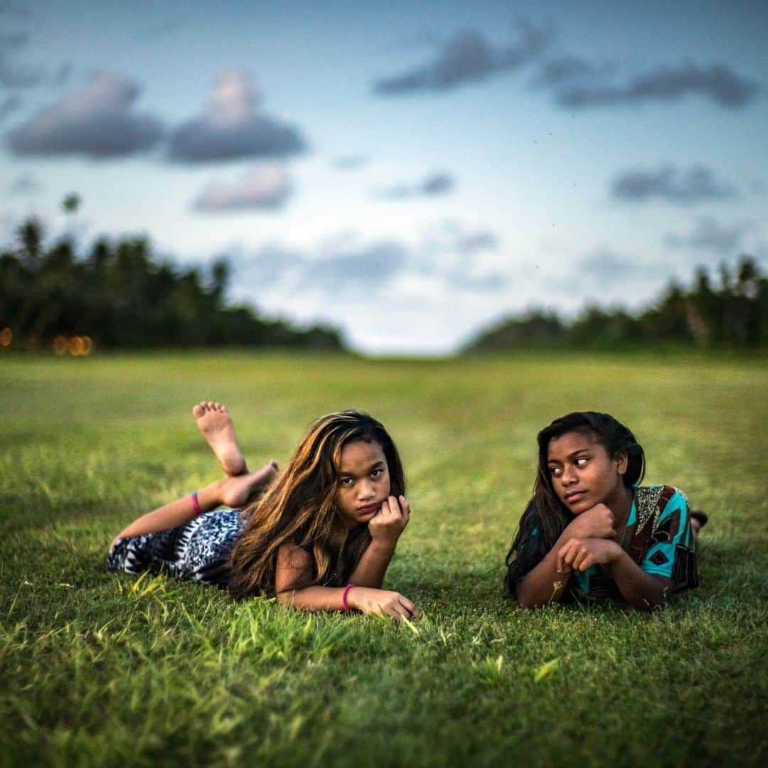 ナショナルジオグラフィックさんのインスタグラム写真 - (ナショナルジオグラフィックInstagram)「Photo by Michael Christopher Brown @michaelchristopherbrown | Young girls take a break on the grass runway on the tiny island of Kili, Marshall Islands. In March 1946 all 167 residents of a small island on a remote Pacific atoll packed up their belongings and left their homes. They were assured it would be for a short period, during which the United States government would carry out a series of nuclear tests. Seventy years later, most surviving Bikini islanders have yet to set foot on the island paradise from which they were evacuated. Those surviving Bikinians and their descendants live scattered among the other Marshall Islands in Micronesia, some on Majuro, the capital, some on Ejit and Kwajalein, and many on Kili, where they eke out a living producing copra, farming what little land is available, and fishing where and when it is safe to do so. For more follow @michaelchristopherbrown.」7月17日 6時34分 - natgeo