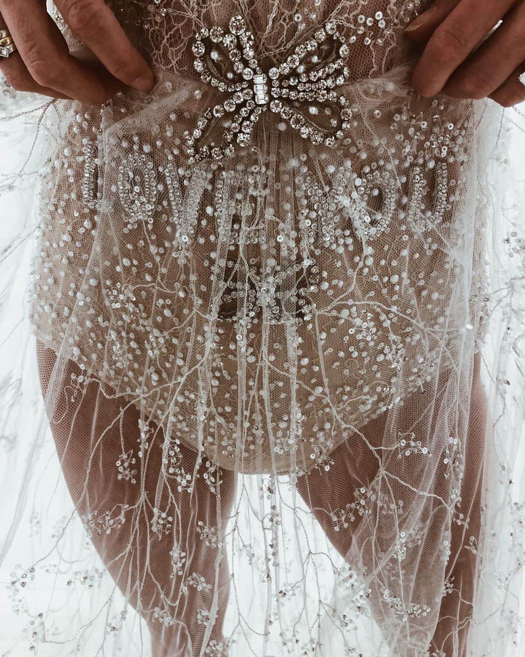 ダニジョーのインスタグラム：「In honor of our girl @danielleasnyder covering the latest issue of @brides magazine (the last ever print issue), she’s taking over their instastory and sharing the details of her search for the perfect #weddingdress. Head on over to watch and get a special discount code to use on her #bridal jewels 👰🏻💎✨ pictured here is her favorite detail of the @reemacrawedding dress she chose: LOVE YOU ❤️」