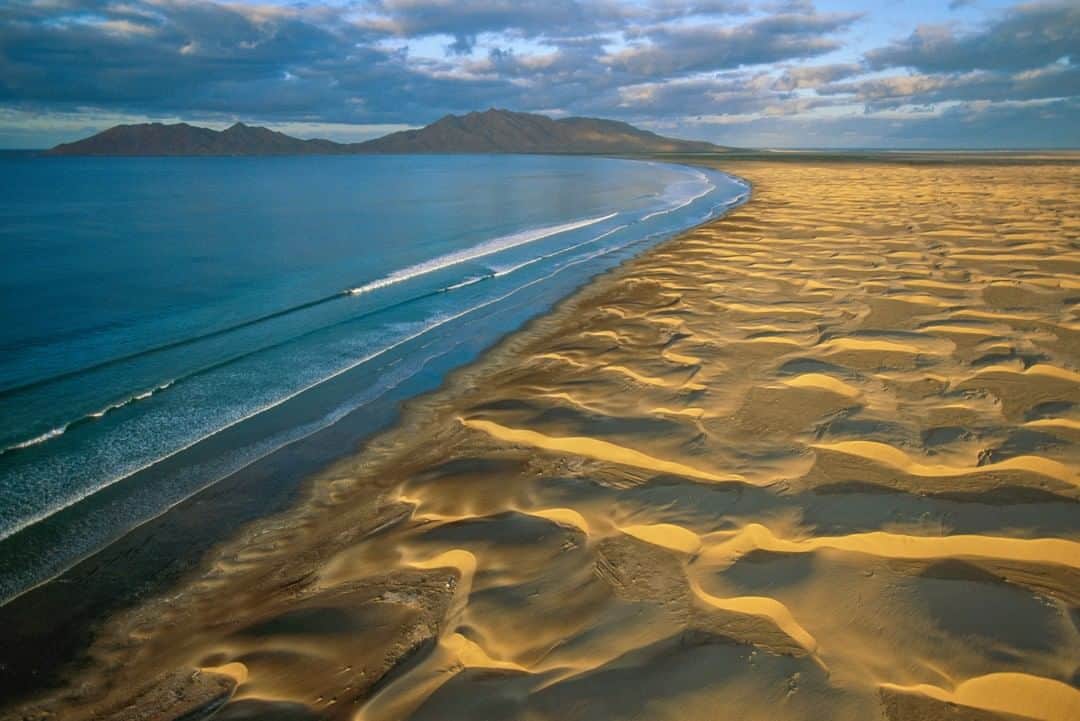 National Geographic Travelさんのインスタグラム写真 - (National Geographic TravelInstagram)「Photo by George Steinmetz @geosteinmetz | A pristine beach on the west coast of Isla Magdalena, on the Pacific side of Baja Californa. Isla Magdalena, along with Isla Santa Margarita, protect Magdalena Bay from harsh Pacific winds, allowing for an inviting environment for gray whales and other marine life. There is a small fishing village on this island and no cars, no roads, and no electricity. To explore more of our world from above, follow me, @geosteinmetz.」7月4日 4時00分 - natgeotravel