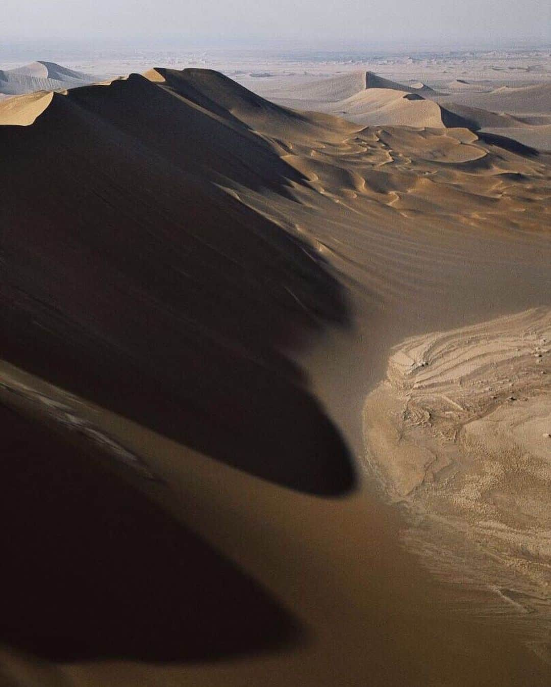 ナショナルジオグラフィックさんのインスタグラム写真 - (ナショナルジオグラフィックInstagram)「Photo by George Steinmetz @geosteinmetz | To fly in remote areas, I always take an expert pilot, like world champion Alan Arnoux, to come back and find me in case things don’t go as planned.  I think we were the first to paraglide in the mega-dunes of the Dasht-e Lut in Iran. NASA satellite analysts say it’s the hottest place on earth, but there was nobody out there with a thermometer. If you want to go exploring, take a #wingman. To see more of our world from above, follow @geosteinmetz」7月4日 5時59分 - natgeo