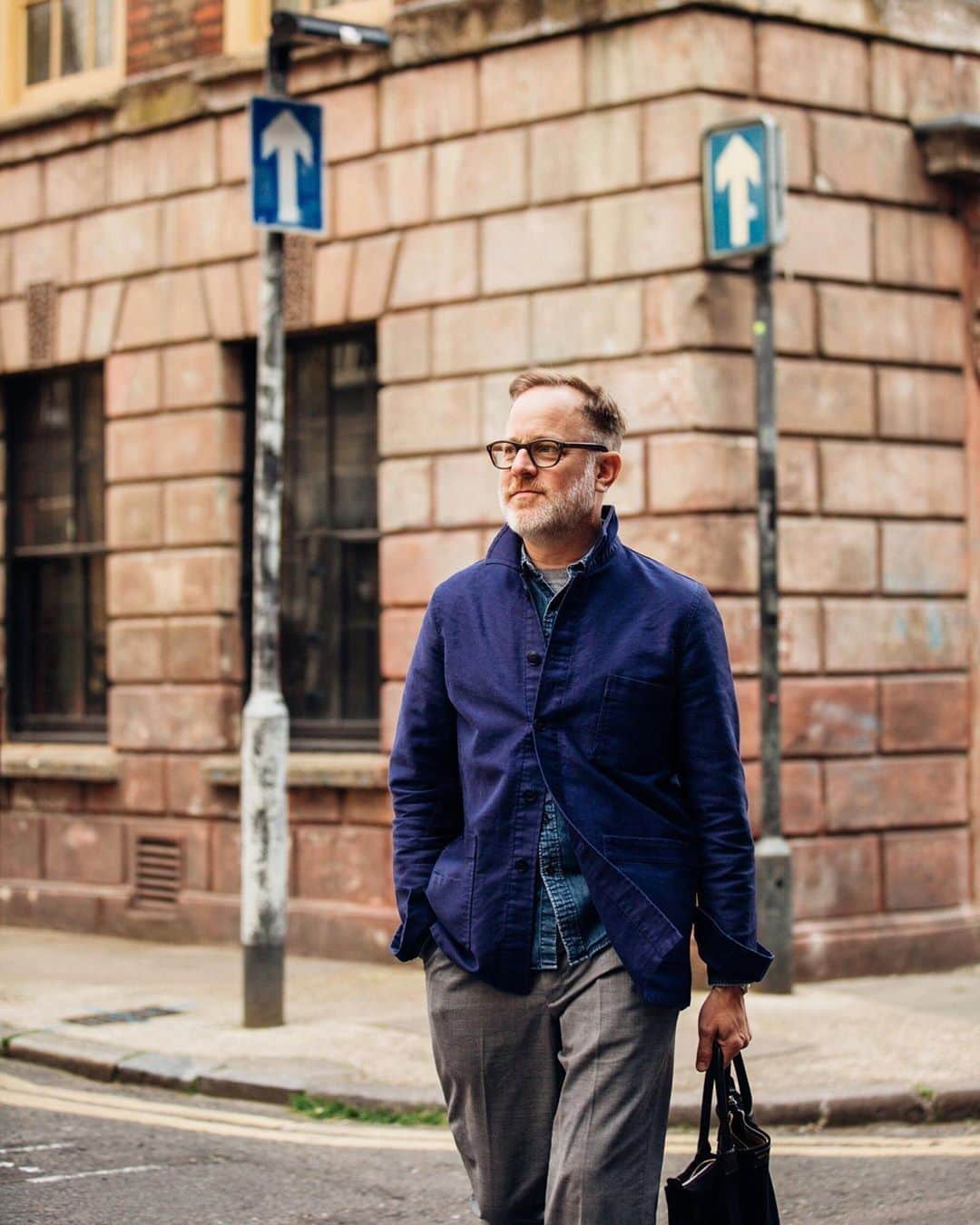 ウォントのインスタグラム：「Spotted: the dapper Bruce Pask wearing our iconic O'Hare tote in London, styled with lightweight tailoring and casual elegance. Designed for every kind of travel, our totes make your commute effortless (Photo via @garconjon) — #repost @brucepask  #wantlesessentiels #wearingWANT #oharetote #menswear #fashion #style」