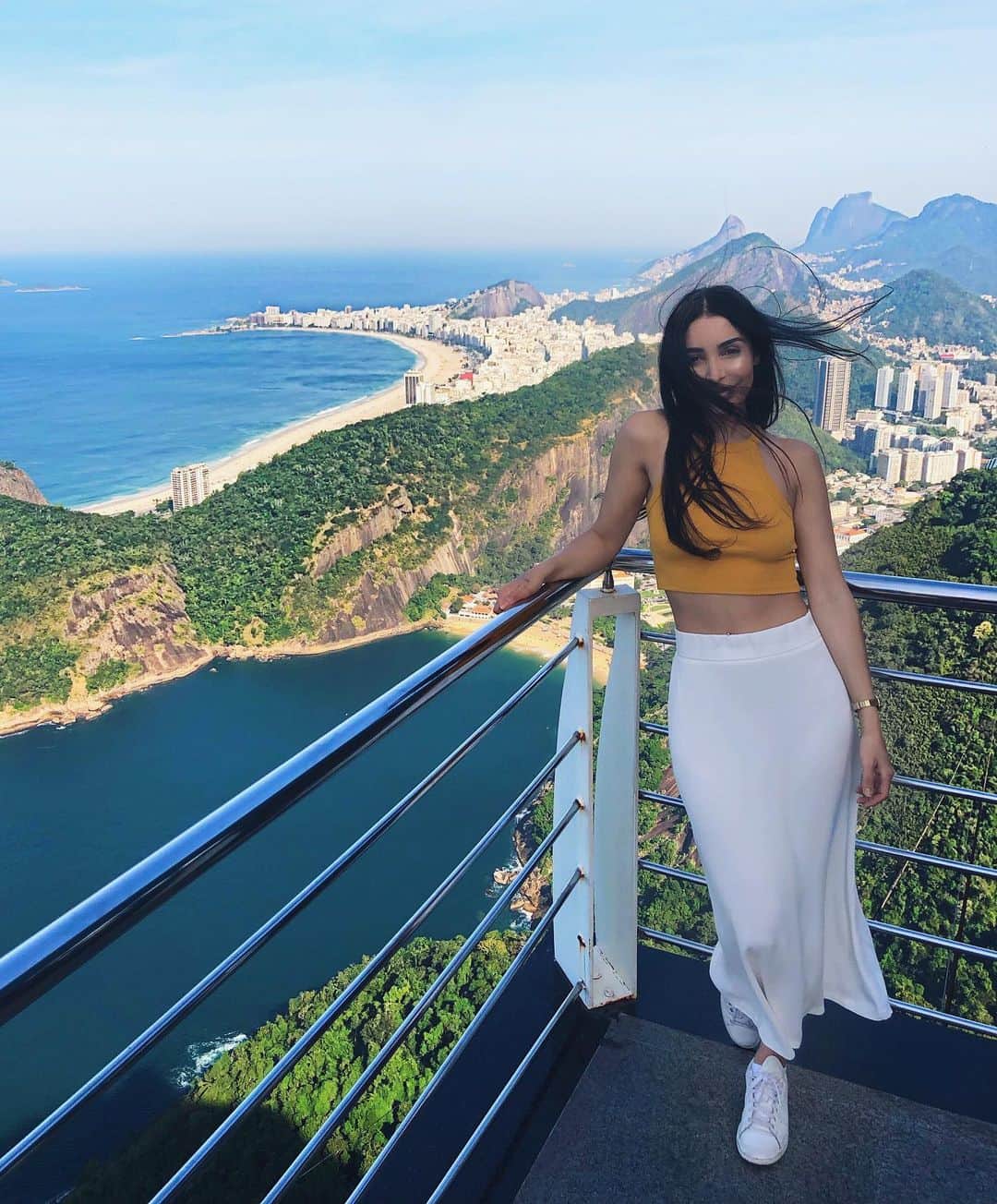 sananasのインスタグラム：「C O P A C A B A N A 🌊Je vous envoie une carte postale ! Cette vue est dingue 😍 Et gros + pour la longue jupe parce que je peux vous dire que le vent là haut ne plaisante pas 😅La plage Copacabana est l’un des endroits les plus animés à Rio ! Vous la reconnaissez grâce à sa forme de croissant 🥐 Ça me donne faim ça ... Total outfit @Zara pour les intéressés 😜j’avais acheté le top et la jupe en soldes. Et aux pieds j’ai mes Stan Smith 😘 Vous avez quoi de prévu aujourd’hui vous ?😃 . . #Copacabana #RioDeJaneiro #OutfitOfTheDay #TuiFrance」