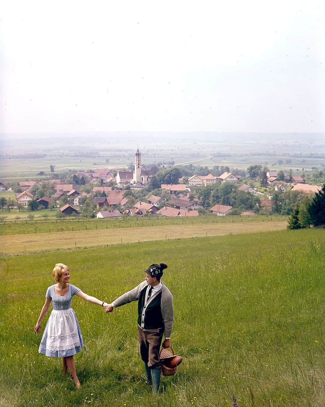 lifeさんのインスタグラム写真 - (lifeInstagram)「Found in the archive: an unpublished set of color photos labeled "Cover Tries for Germany Book" - May 19, 1961. According to the notes, this scene was from the 4th set shot on Kodachrome - "Bavaria: village Pahl in background with alpine meadow in foreground on which young Bavarian girl, Evelin Bey, 24, and local butcher, Adolf Klein, 21, are going for a picnic." (Stan Wayman—The LIFE Picture Collection/Getty Images) #unpublished Kodachrome #Germany」7月7日 22時53分 - life