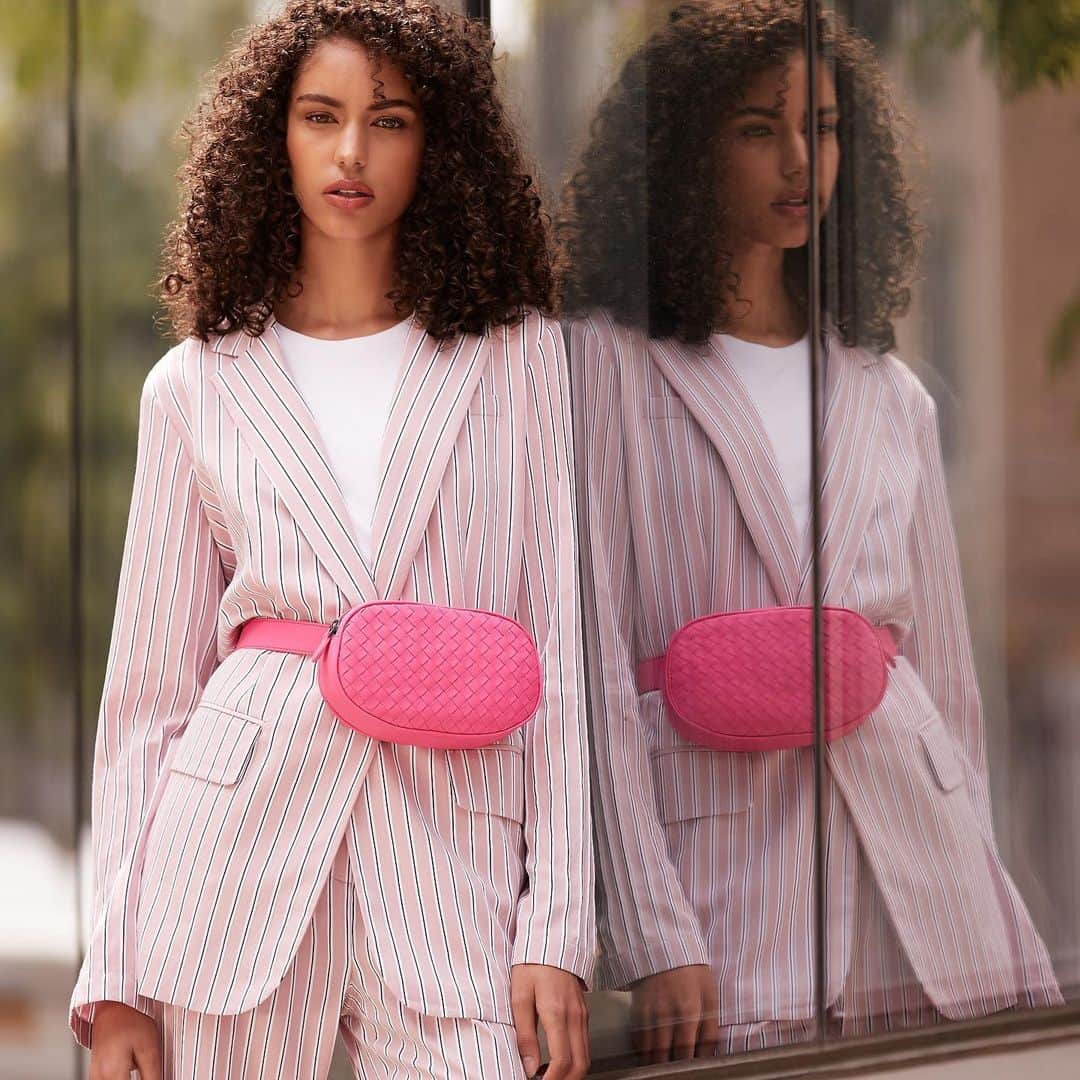 Saks Fifth Avenueのインスタグラム：「POWER PINKS: Mix and match similar hues of the shade, like this neon @bottegaveneta belt bag and pinstripe suit from @tibi. #SaksStyle」