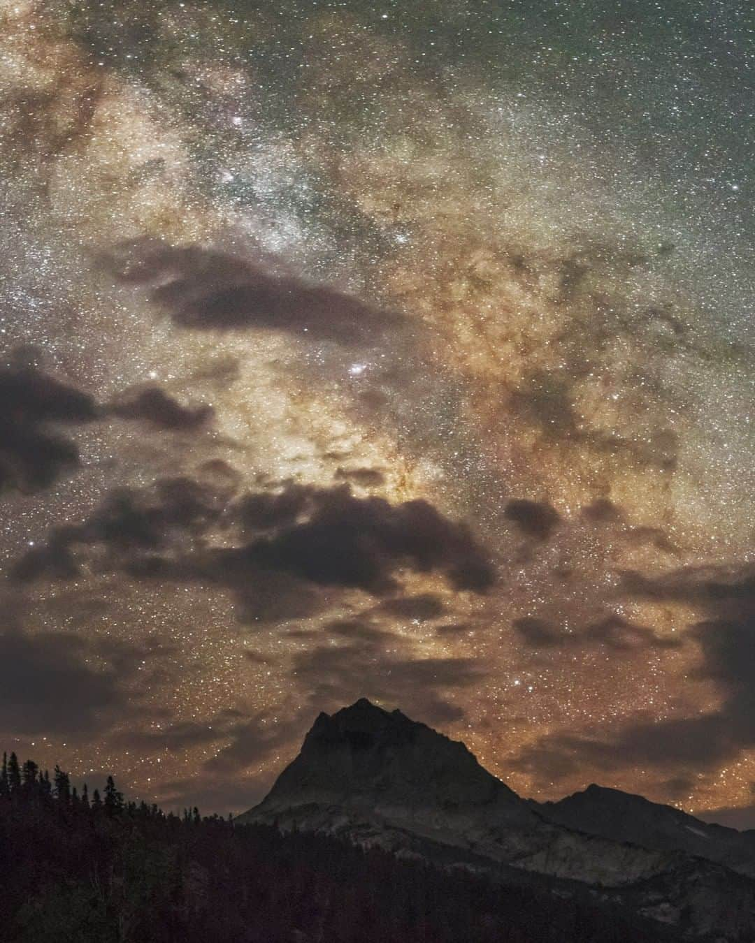 National Geographic Travelさんのインスタグラム写真 - (National Geographic TravelInstagram)「Photo by @BabakTafreshi | A summer night in the high Sierras in California. This place is far from city lights at an altitude of 10,000 ft. (3050 m.). In this single-exposure photograph, the bright core of the Milky Way in constellation Sagittarius is seen through passing clouds. Down on Earth is Hurd Peak in the Sierra Nevada mountains. Explore more of The World at Night photography with me, @babaktafreshi. #sierra #astrophotography」7月8日 7時00分 - natgeotravel