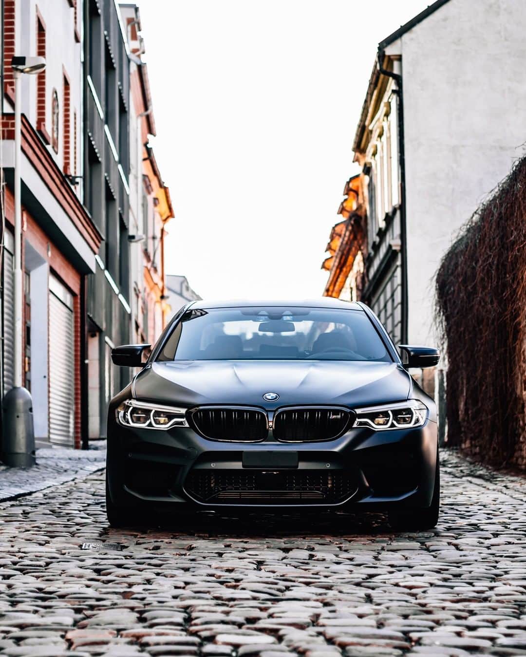 BMWのインスタグラム：「Legendary presence of power. The BMW M5 Sedan. #TheM5 #BMW #M5 #BMWM #BMWrepost @georgiancollector  __ BMW M5 Sedan: Fuel consumption in l/100 km (combined): 10.8 - 10.7. CO2 emissions in g/km (combined): 246 - 243. The values of fuel consumptions, CO2 emissions and energy consumptions shown were determined according to the European Regulation (EC) 715/2007 in the version applicable at the time of type approval. The figures refer to a vehicle with basic configuration in Germany and the range shown considers optional equipment and the different size of wheels and tires available on the selected model. The values of the vehicles are already based on the new WLTP regulation and are translated back into NEDC-equivalent values in order to ensure the comparison between the vehicles. [With respect to these vehicles, for vehicle related taxes or other duties based (at least inter alia) on CO2-emissions the CO2 values may differ to the values stated here.] The CO2 efficiency specifications are determined according to Directive 1999/94/EC and the European Regulation in its current version applicable. The values shown are based on the fuel consumption, CO2 values and energy consumptions according to the NEDC cycle for the classification. For further information about the official fuel consumption and the specific CO2 emission of new passenger cars can be taken out of the „handbook of fuel consumption, the CO2 emission and power consumption of new passenger cars“, which is available at all selling points and at https://www.dat.de/angebote/verlagsprodukte/leitfaden-kraftstoffverbrauch.html.」