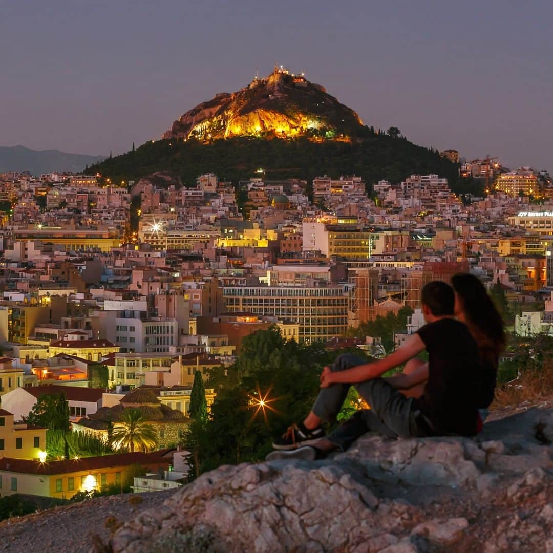 National Geographic Travelさんのインスタグラム写真 - (National Geographic TravelInstagram)「Photo by @BabakTafreshi | A young couple enjoy the view of Athens, Greece from a hilltop in a summer dusk. Explore more of The World at Night photography with me, @babaktafreshi. #greece #athens #nightphotography」7月12日 7時00分 - natgeotravel